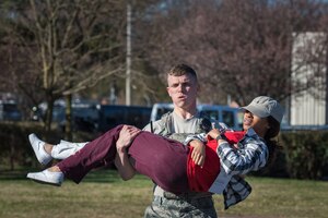 U.S. Air Force Senior Airman Hudson Aldrich, 633rd Security Forces Squadron response force leader, carries a role-player with a simulated leg wound during an active shooter exercise at Langley Air Force Base, Virginia, March 27, 2019.