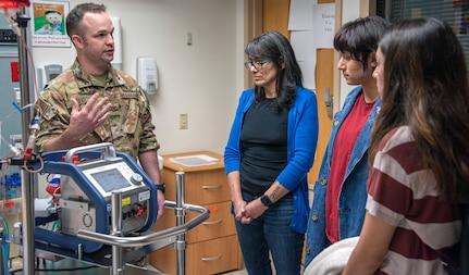 Air Force Maj. (Dr.) Matthew Read, acting Extracorporeal Membrane Oxygenation medical director, demonstrates the ECMO machine for Rita Ibanez and her children at Brooke Army Medical Center, Fort Sam Houston, Texas, March 22, 2019. The adult ECMO mission began at BAMC in 2012. Today, a designated team of Army, Air Force and Navy physicians, nurses, technicians and program managers is able to provide round-the-clock care to four patients simultaneously.