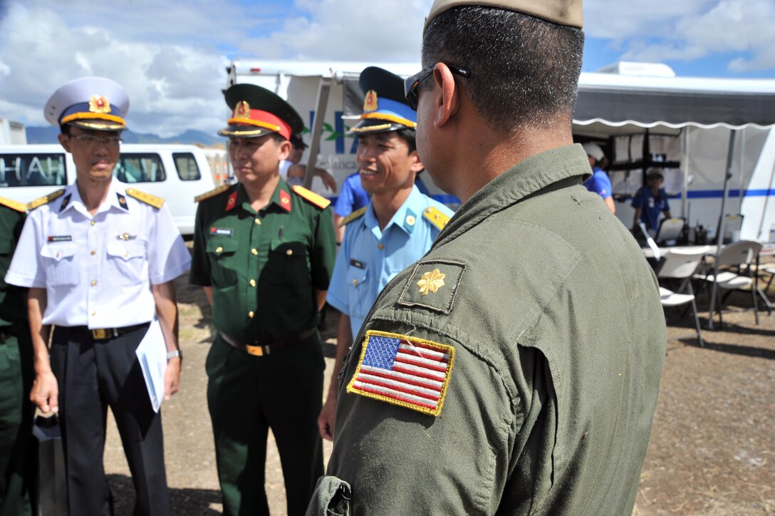 Men in various military uniforms stand around.