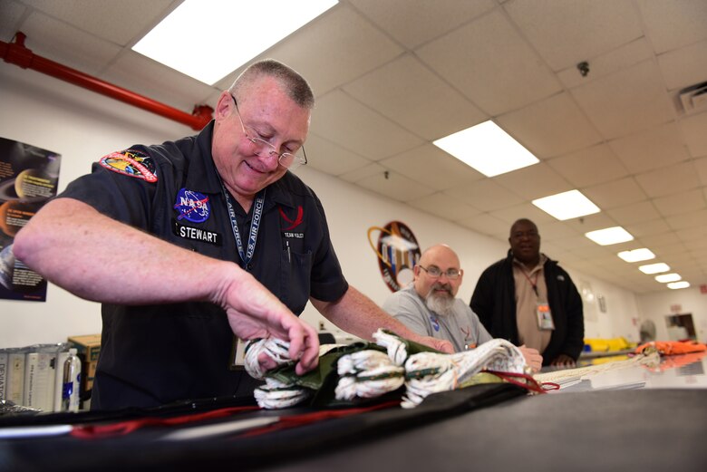 Troy Stewart, a personal equipment technician contractor for NASA Aircraft Operations, stows parachute lines at Ellington Airport, Texas, March 27, 2019. Stewart, a 30-year veteran in the life support field, has packed his fair share of parachutes in his time, and has now added the T-38 Talon’s parachute to the list. (U.S. Air Force photo by Senior Airman Benjamin N. Valmoja)