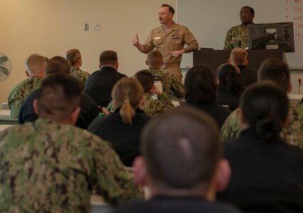 Chief Petty Officer Mark Francesco, an instructor with the Biomedical Technician program at the Medical Education and Training Campus at Joint Base San Antonio-Fort Sam Houston, speaks to students of the Hospital Corpsman Basic program about the Navy-Marine Corps Relief Society.