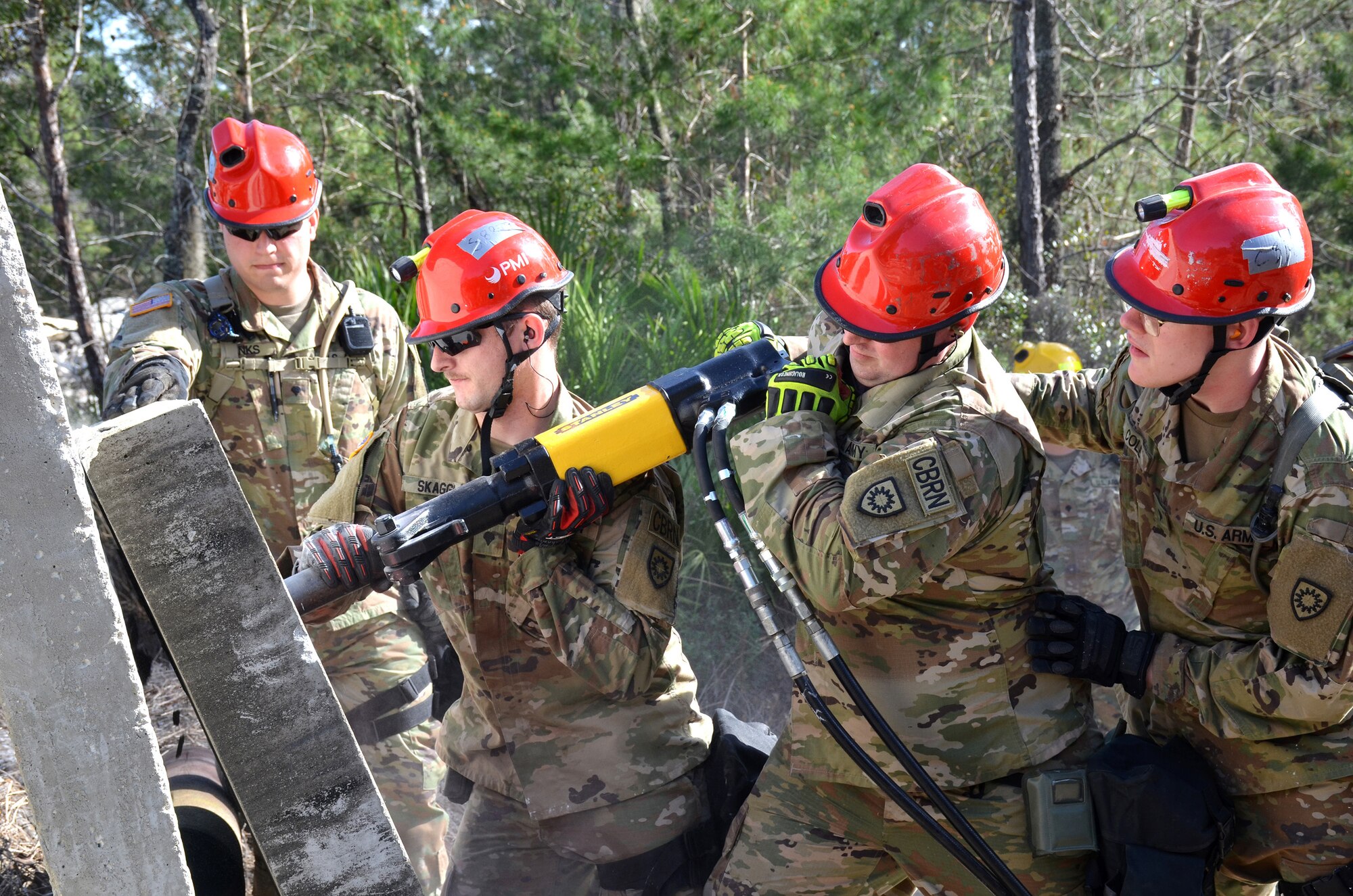 Soldiers with the Kentucky National Guard CBRNE Enhanced Response Force Package, or CERFP, use a hammer drill to extract a simulated victim from a rubble pile during an exercise evaluation at Camp Blanding, Fla., Jan. 10, 2019. The CERFP was tasked with responding to a 10-kiloton nuclear explosion, establishing a support zone, searching the hot zone for victims, extracting and decontaminating the victims, and providing medical assistance. (U.S. Army National Guard photo by Sgt. Taylor Tribble)