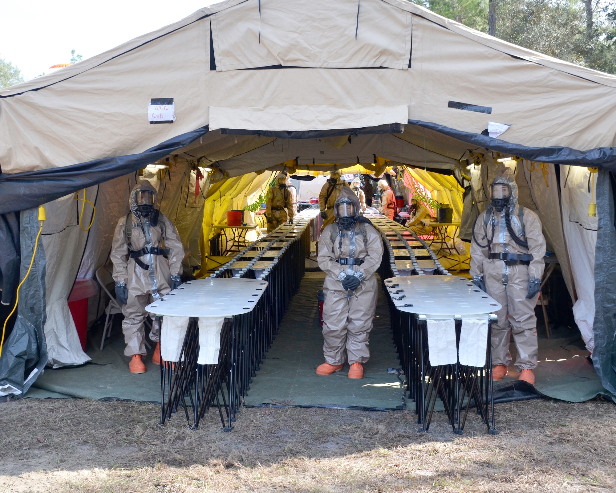 Guardsmen with Kentucky's CBRNE Enhanced Response Force Package, or CERFP, prepare their decontamination station to process non-ambulatory simulated victims during an exercise evaluation at Camp Blanding, Fla., Jan. 10, 2019. The CERFP was tasked with responding to a 10-kiloton nuclear explosion, establishing a support zone, searching the hot zone for victims, extracting and decontaminating the victims, and providing medical assistance. (U.S. Army National Guard photo by Sgt. Taylor Tribble)
