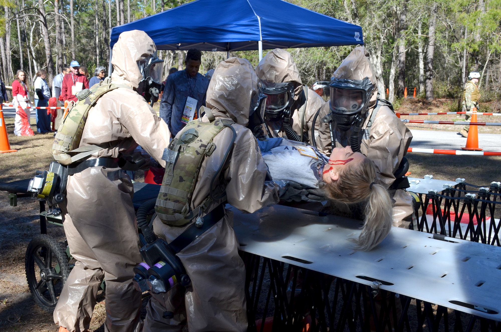 Guardsmen from Kentucky's CBRNE Enhanced Response Force Package, or CERFP, move a simulated victim from a litter to their decontamination station during an exercise evaluation at Camp Blanding, Fla., Jan. 10, 2019. The CERFP was tasked with responding to a 10-kiloton nuclear explosion, establishing a support zone, searching the hot zone for victims, extracting and decontaminating the victims, and providing medical assistance. (U.S. Army National Guard photo by Sgt. Taylor Tribble)