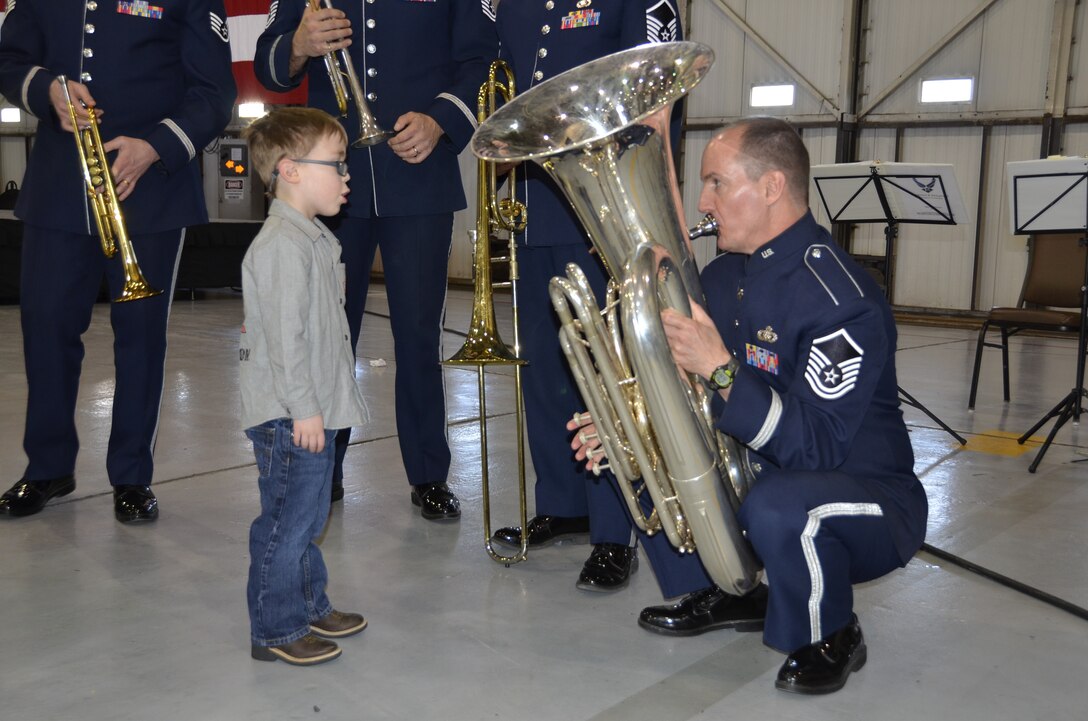 MSgt Alex Serwatowski, tubist with the USAF Heartland of America Band demonstrated his instrument to a young listener.