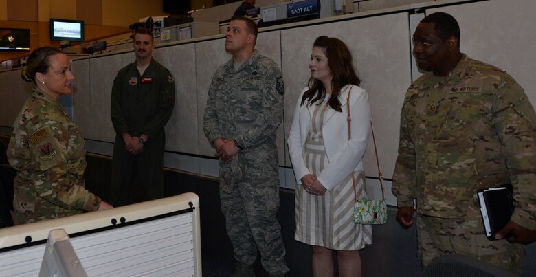 Chief Master Sgt. Karrie Bennett, 601st Chief Enlisted Manager, briefs some of the Continental U.S. Aerospace Defense Region 2018 annual award winners along with a spouse during a tour of the 601st Air Operations Center March 27. (U.S. Air Force photo by Mary McHale)