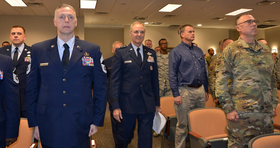 Attendees at the Continental U.S. NORAD Region-1st Air Force (Air Forces Northern) 2018 Annual Award Ceremony stand at attention as Lt. Gen. R. Scott Williams, CONR – 1 AF (AFNORTH) Commander, enters the auditorium to open the event. (U.S. Air Force photo by Mary McHale)