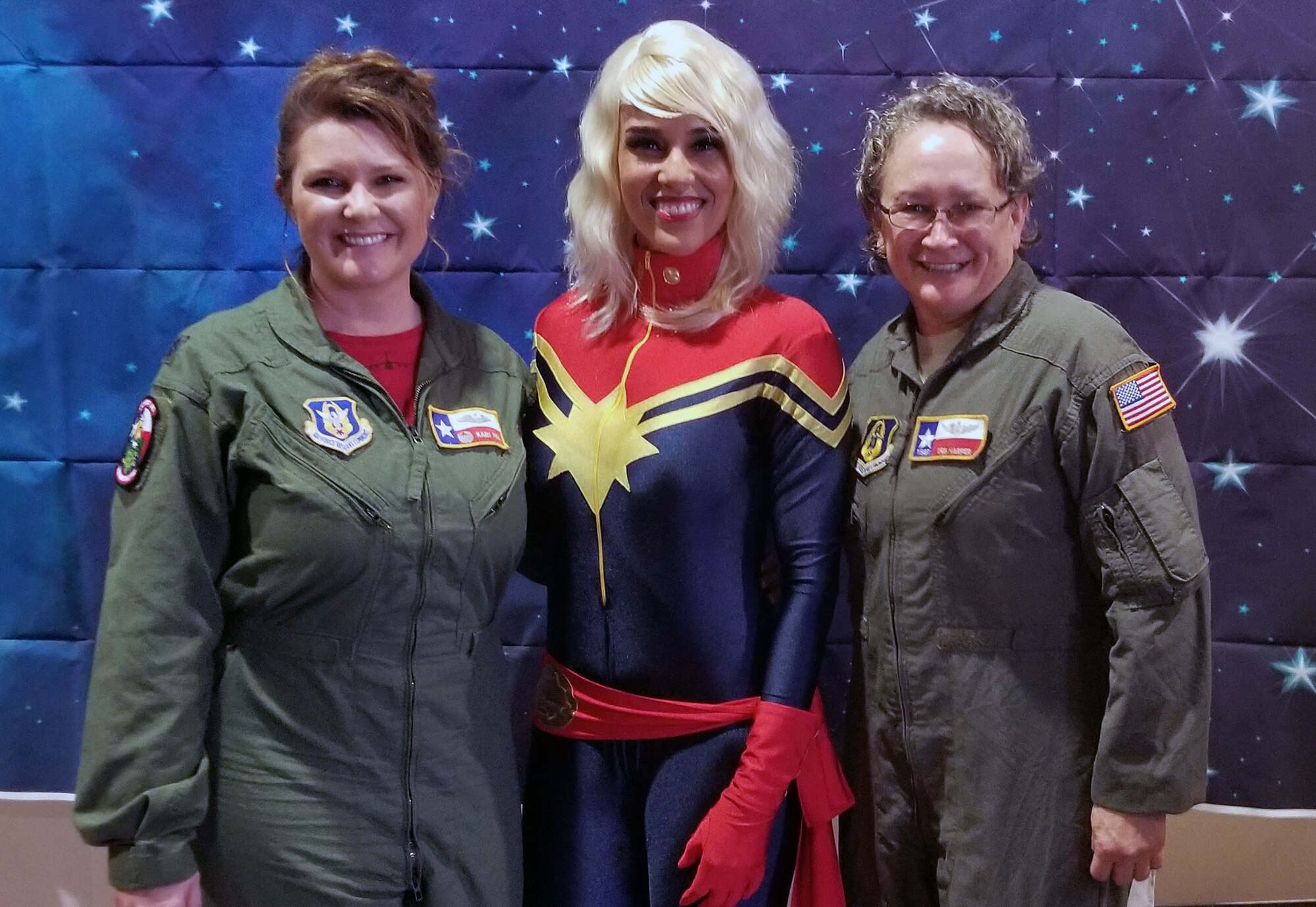 Lt. Col. Kari Hill, 433rd Operations Support Squadron commander/pilot, and Tech. Sgt. Debra Hill, 68th Airlift Squadron loadmaster, both with Joint Base San Antonio-Lackland, Texas, pose with Rebecca Sorenson, owner of Chic Basics, and a domestic engineer, March 23, 2019, during the “Marvelous Women Don’t Need Capes” event at the Alamo Drafthouse movie cinema in San Antonio.