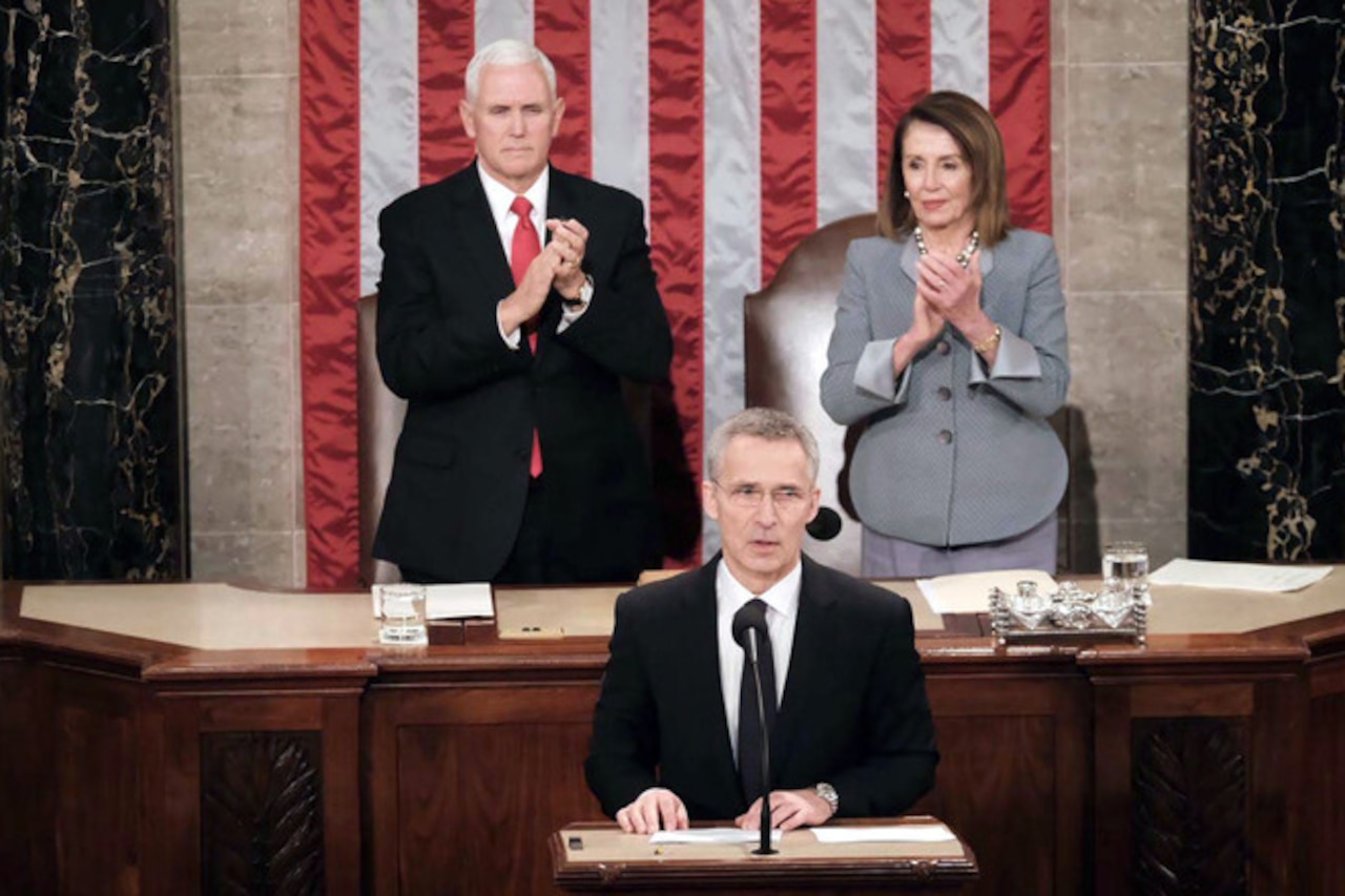 A man speaks at lectern in House chamber.