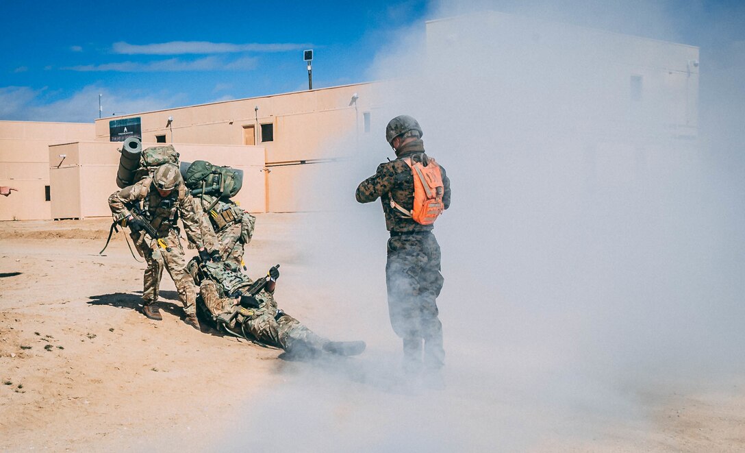 U.K. Royal Marines with 45 Commando, perform a casualty evacuation during Integrated Training Exercise (ITX) 2-19 at Range 220, Marine Corps Air Ground Combat Center, Twentynine Palms, Calif. Feb. 9, 2019. ITX creates a challenging, realistic training environment that produces combat-ready forces capable of operating as an integrated Marine Air Ground Task Force. (U.S. Marine Corps photo by Cpl. Jennessa Davey)