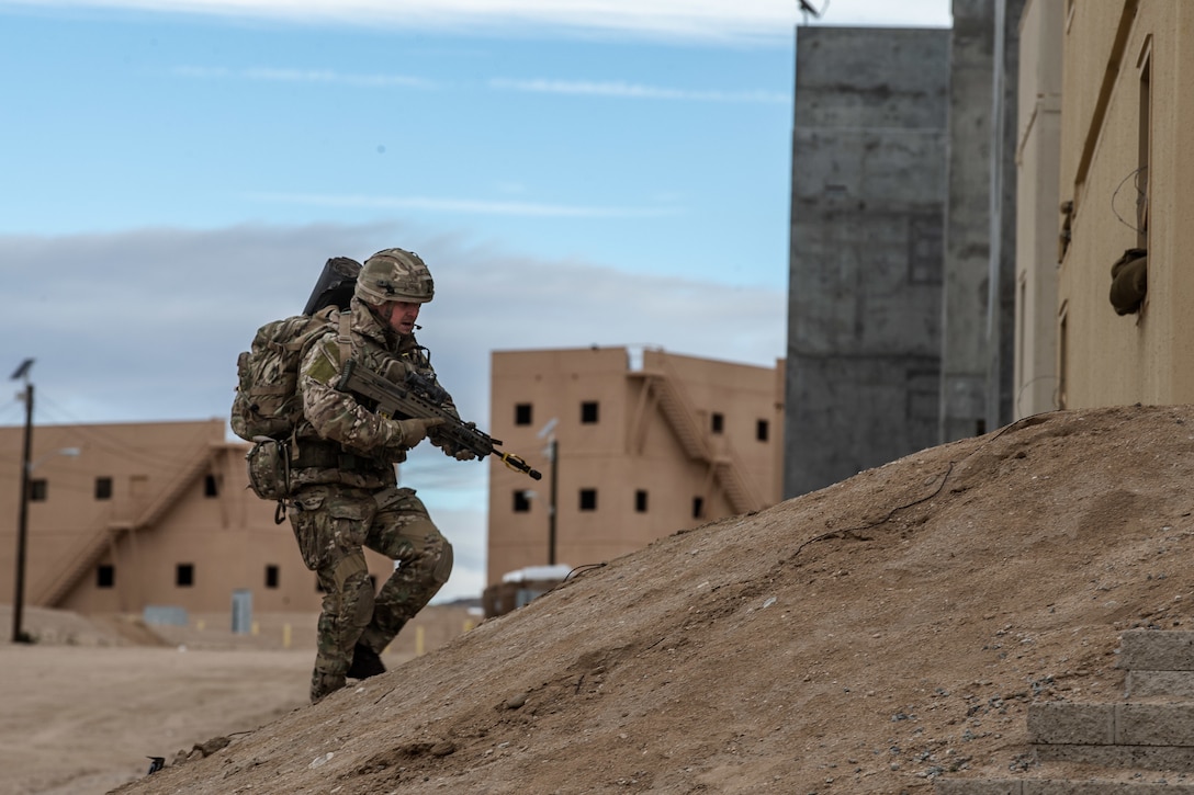 A U.K. Royal Marine with 45 Commando advances position during Integrated Training Exercise (ITX) 2-19 at Range 220, Marine Corps Air Ground Combat Center, Twentynine Palms, Calif. Feb. 9, 2019. ITX creates a challenging, realistic training environment that produces combat-ready forces capable of operating as an integrated Marine Air Ground Task Force. (U.S. Marine Corps photo by Cpl. Conner Downey)