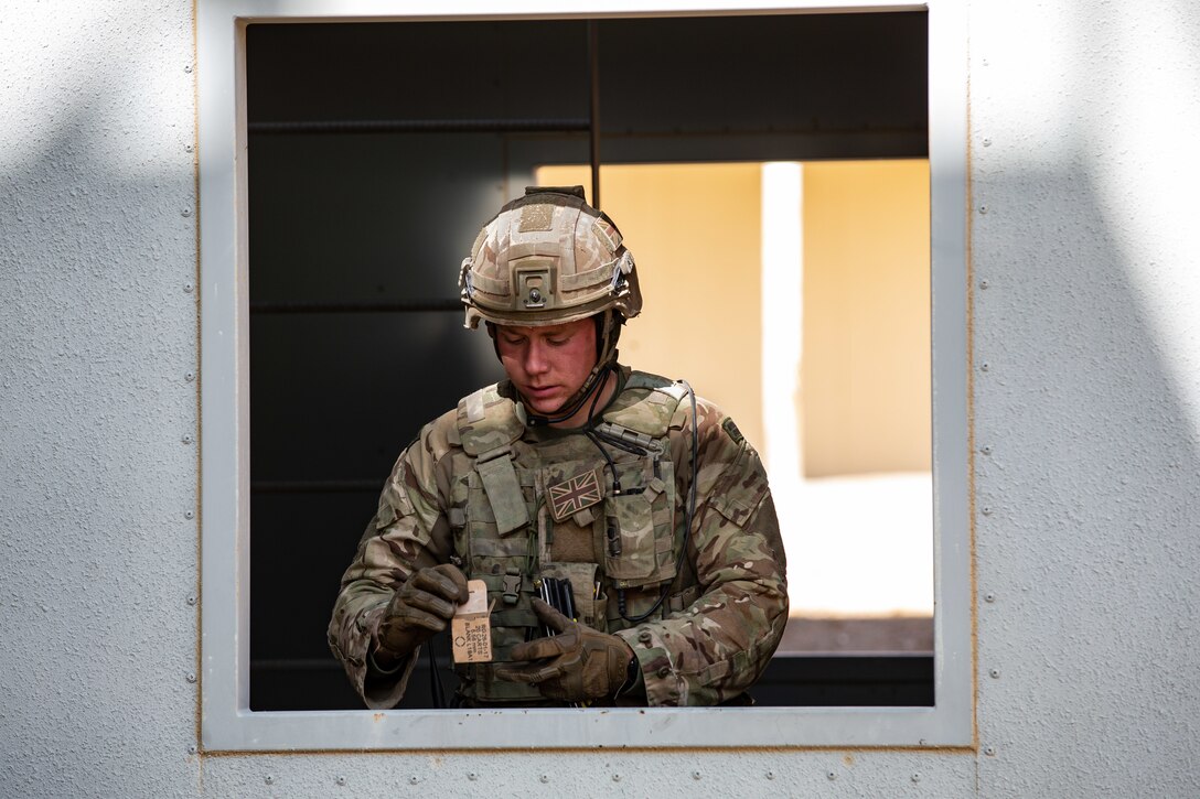 A U.K. Royal Marine with 45 Commando reloads his magazines during Integrated Training Exercise (ITX) 2-19 at Range 220, Marine Corps Air Ground Combat Center, Twentynine Palms, Calif. Feb. 9, 2019. ITX creates a challenging, realistic training environment that produces combat-ready forces capable of operating as an integrated Marine Air Ground Task Force. (U.S. Marine Corps photo by Cpl. Conner Downey)
