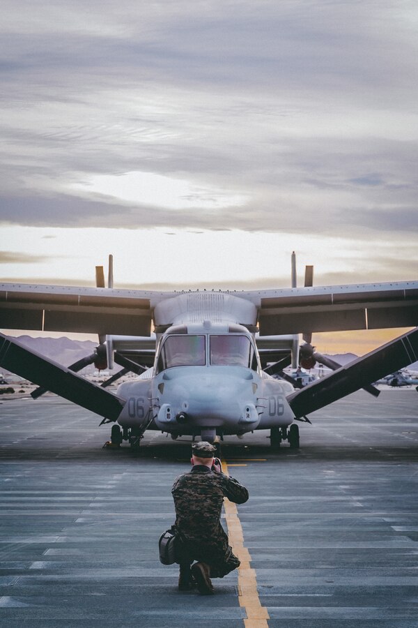 U.S Marine Pfc. Cedar Barnes, combat photographer, Communication Strategy and Operations, Marine Air Ground Task Force Training Command, Marine Corps Air Ground Combat Center (MCAGCC), photographs an MV-22 Osprey with Marine Aircraft Group 13, 3rd Marine Aircraft Wing on the flightline in preparation for a training exercise on Marine Corp Air Ground Combat Center, Twentynine Palms, Calif., Feb 15, 2019. Exercises such as this provide realistic training necessary for 3rd MAW as the Marine Corps’ Largest aircraft wing and ensures the unit remains ready. (U.S. Marine Corps photo by Lance Cpl. Colton Brownlee)