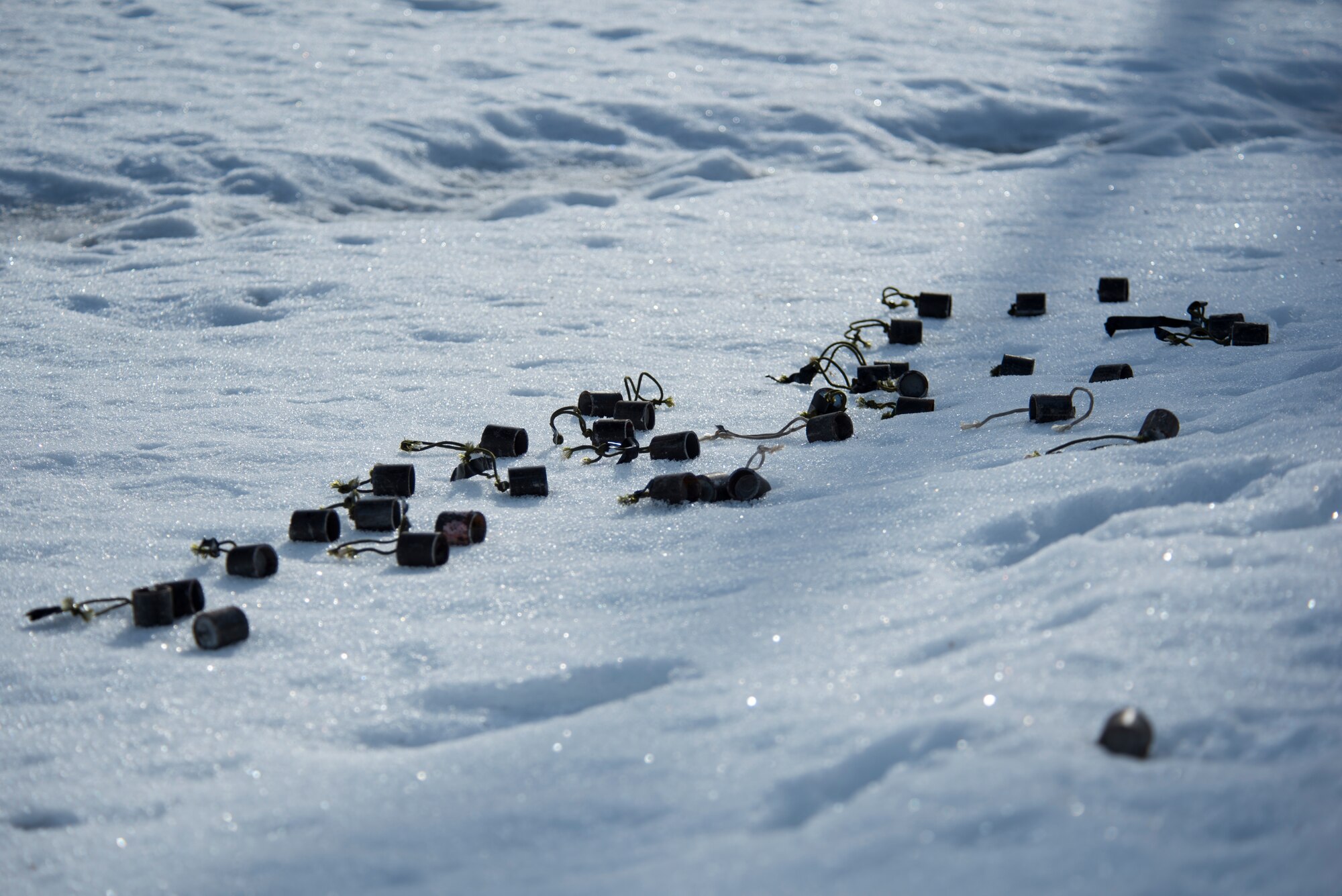 673d Civil Engineer Squadron Explosive Ordnance Disposal Airmen stack simulated submunitions in the snow during Polar Force 19-4 at Joint Base Elmendorf-Richardson, Alaska, April 2, 2019. Polar Force is a two-week exercise designed to test JBER’s mission readiness and strengthen and develop the skills service members require when facing adverse situations.