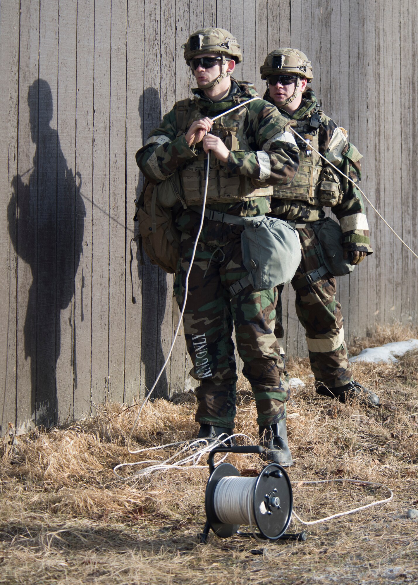 Senior Airman Dillan Owen and U.S. Air Force Staff Sgt. Jonmical Harry, 673d Civil Engineer Squadron Explosive Ordnance Disposal, pull on a rope to detonate simulated submunitions in a simulated chemical environment during Polar Force 19-4 at Joint Base Elmendorf-Richardson, Alaska, April 2, 2019. Polar Force is a two-week exercise designed to test JBER’s mission readiness and strengthen and develop the skills service members require when facing adverse situations.