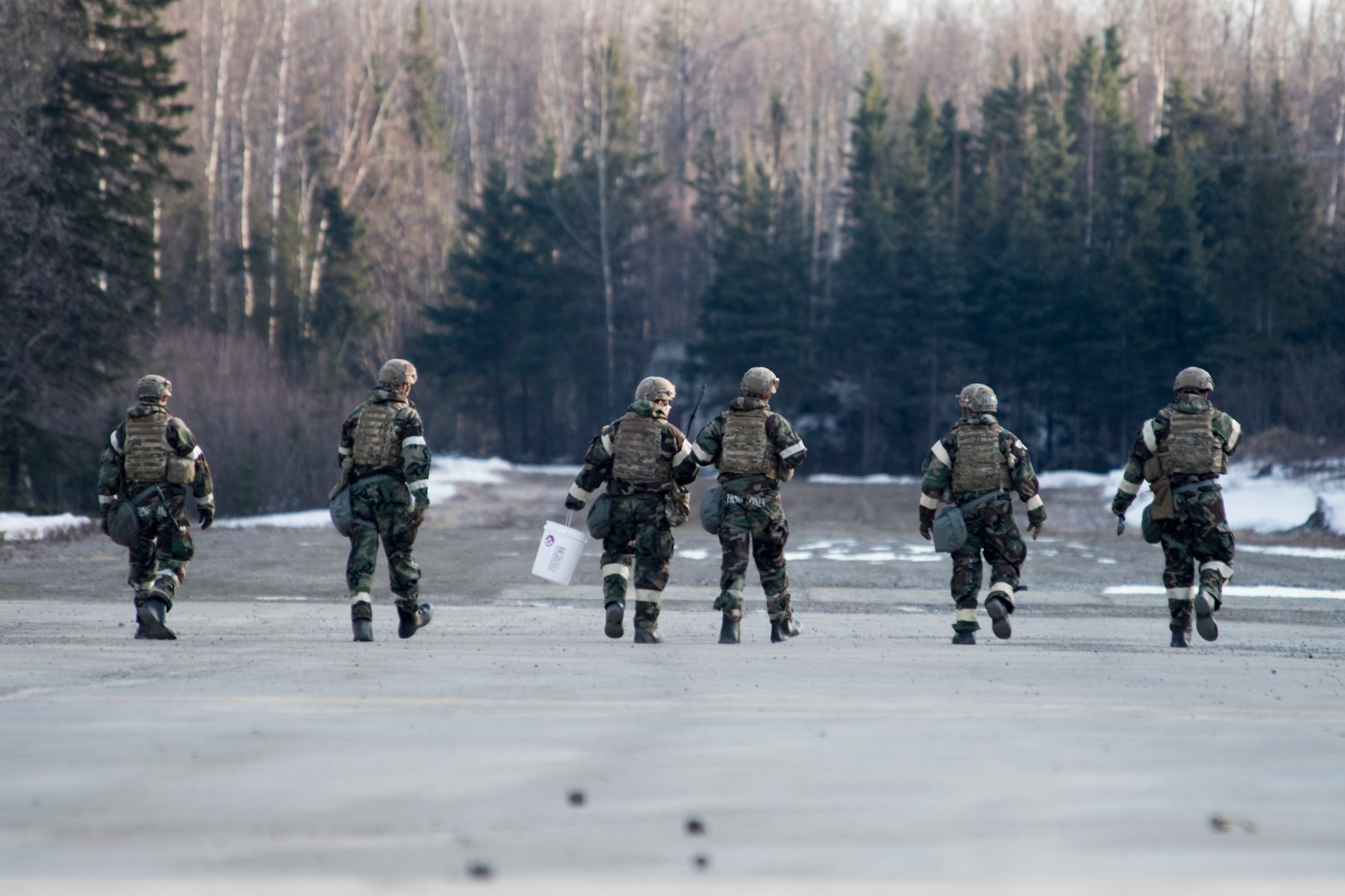 Explosive Ordnance Disposal Airmen conduct rapid clearing of submunitions on an airfield in a simulated chemical environment during Polar Force 19-4 at Joint Base Elmendorf-Richardson, Alaska, April 2, 2019. Polar Force is a two-week exercise designed to test JBER’s mission readiness and strengthen and develop the skills service members require when facing adverse situations.