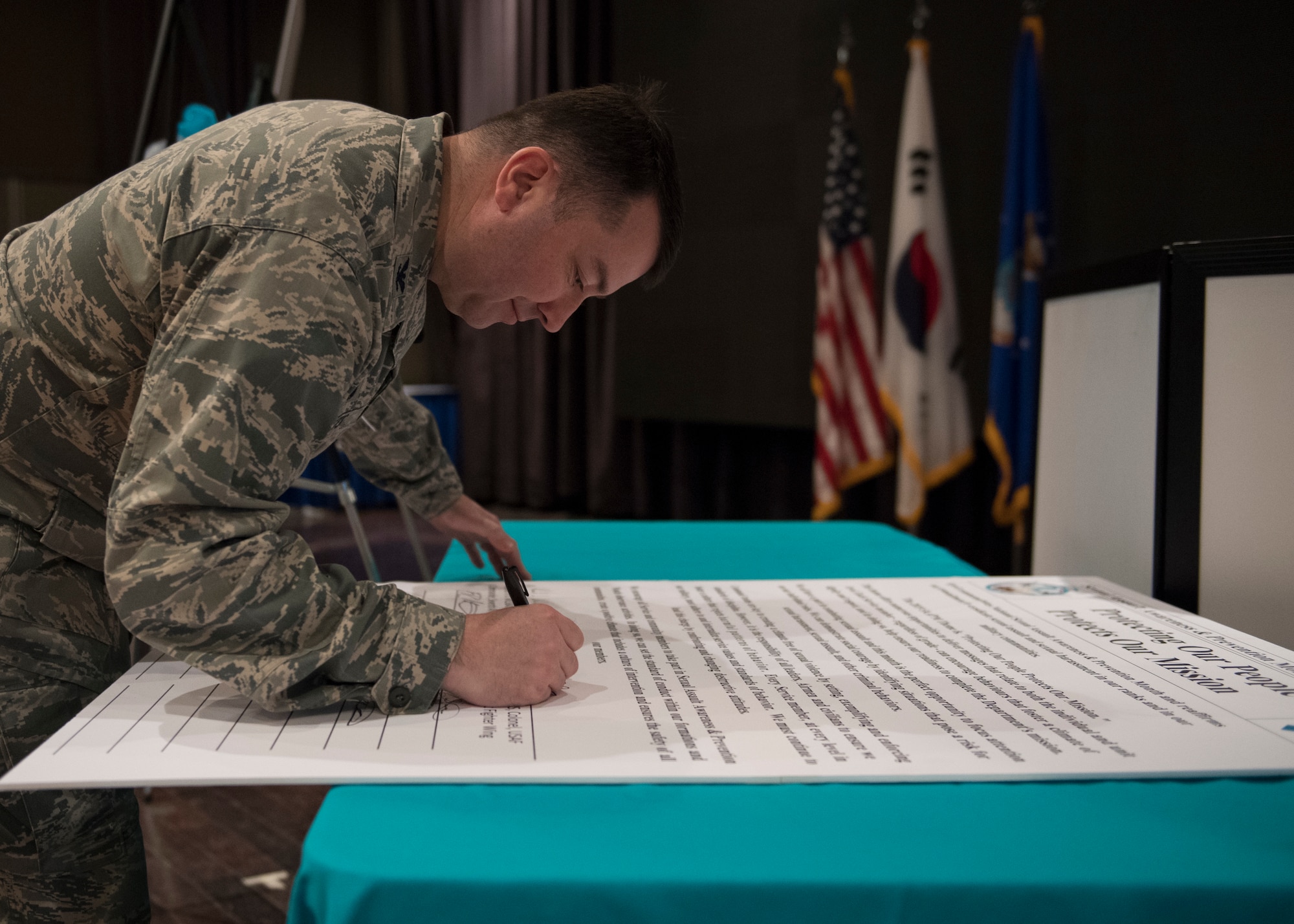 U.S. Air Force Col. William Betts, commander of the 51st Fighter Wing, signs a proclamation for the kickoff of Sexual Assault Awareness and Prevention Month at Osan Air Base, Republic of Korea, April 3, 2019. By signing the proclamation, Betts pledged Team Osan’s commitment to make every effort to reduce and eliminate sexual assaults here and across the Air Force. (U.S. Air Force photo by Staff Sgt. Ramon A. Adelan)