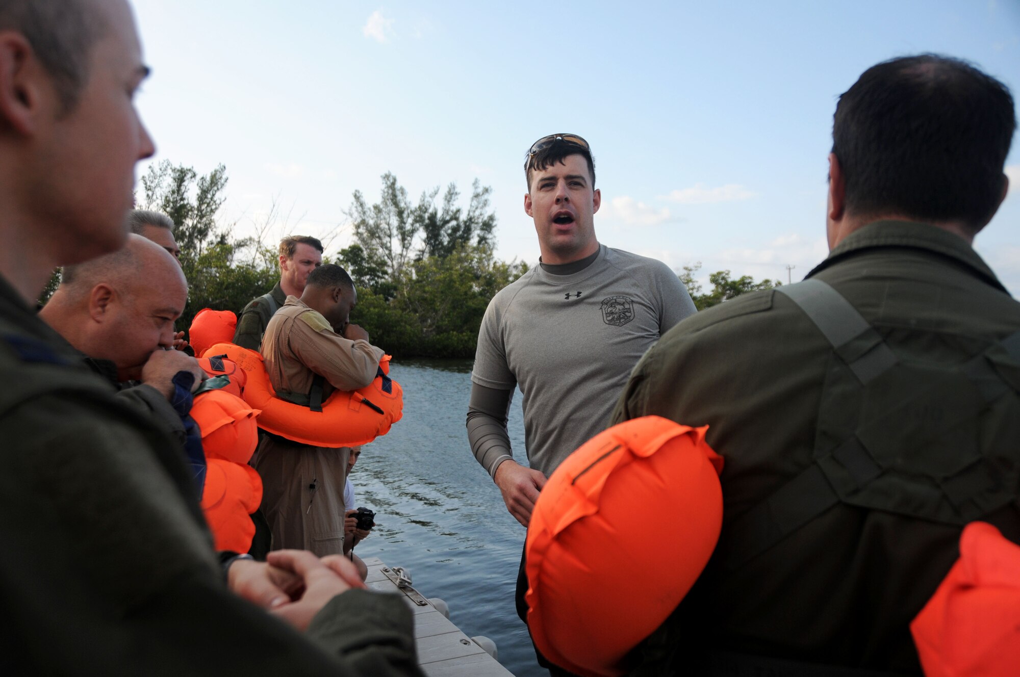 A Survival, Evade, Resistance and Escape trainer instructs members of the 94th Operations Group during Water Survival Training at Naval Air Station Key West, Florida March 27, 2019. During the two-day Survival, Evasion, Resistance and Escape course Airmen participated in Self Aid Buddy Care, water survival training, and navigational training in an urban environment. (U.S. Air Force photo/Senior Airman Justin Clayvon)