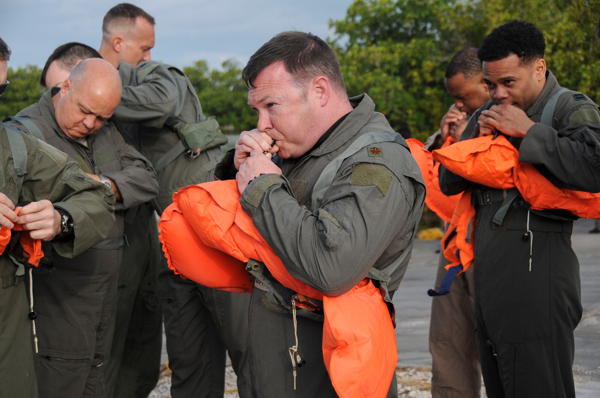 Members of the 94th Operations Group inflate flotation devices during Water Survival Training at Naval Air Station Key West, Florida March 27, 2019. During the two-day Survival, Evasion, Resistance and Escape course, members also completed Self Aid Buddy Care and combat survival. (U.S. Air Force photo/Senior Airman Justin Clayvon)