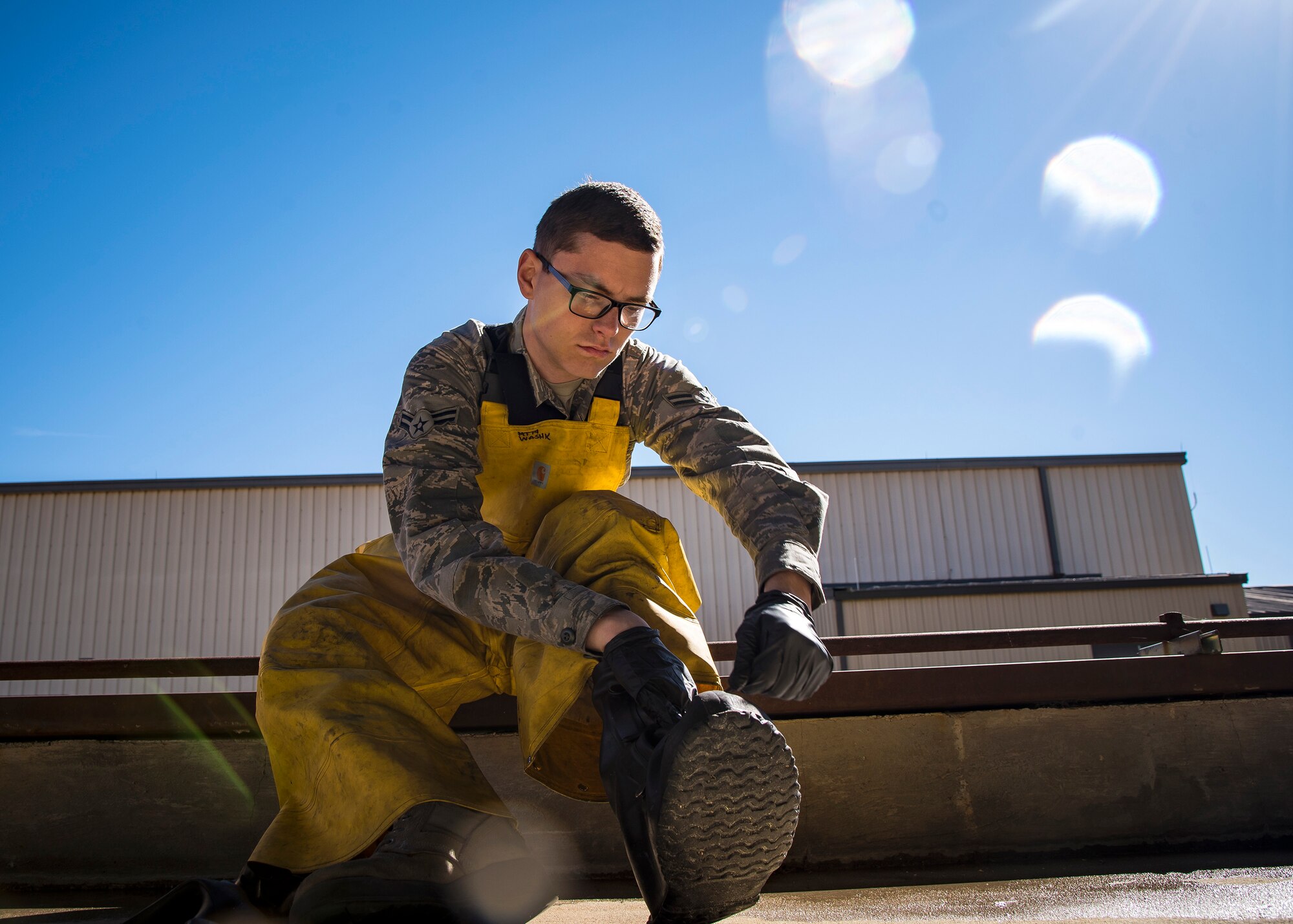 Airman 1st Class Alec Whitacre, 74th Aircraft Maintenance Unit munitions specialist, puts on his personal protective equipment prior to an A-10C Thunderbolt II wash, Feb. 25, 2019, at Moody Air Force Base, Ga. To guarantee Moody’s fleet of 49 A-10s are in peak warfighting condition, Airmen from the 23d Maintenance Group dedicated over 10 hours washing the A-10 to ensure their aircraft is free of any surface or structural deficiencies that could present a safety hazard during flight. (U.S. Air Force photo by Airman 1st Class Eugene Oliver)