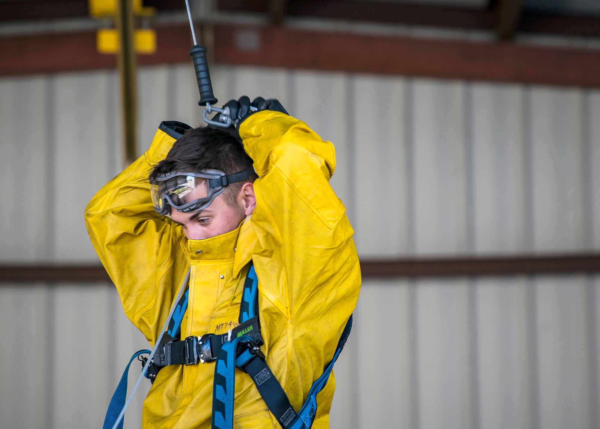 Airman 1st Class Benjamin Jones, 74th Aircraft Maintenance Unit (AMU) crew chief, attaches a hook to a harness, Feb. 25, 2019, at Moody Air Force Base, Ga. On top of their daily scheduled maintenance a team of six Airmen dedicated over 10 hours washing an A-10C Thunderbolt II to ensure the aircraft was free of any surface or structural deficiencies that could present a safety hazard during flight. (U.S. Air Force photo by Airman 1st Class Eugene Oliver)