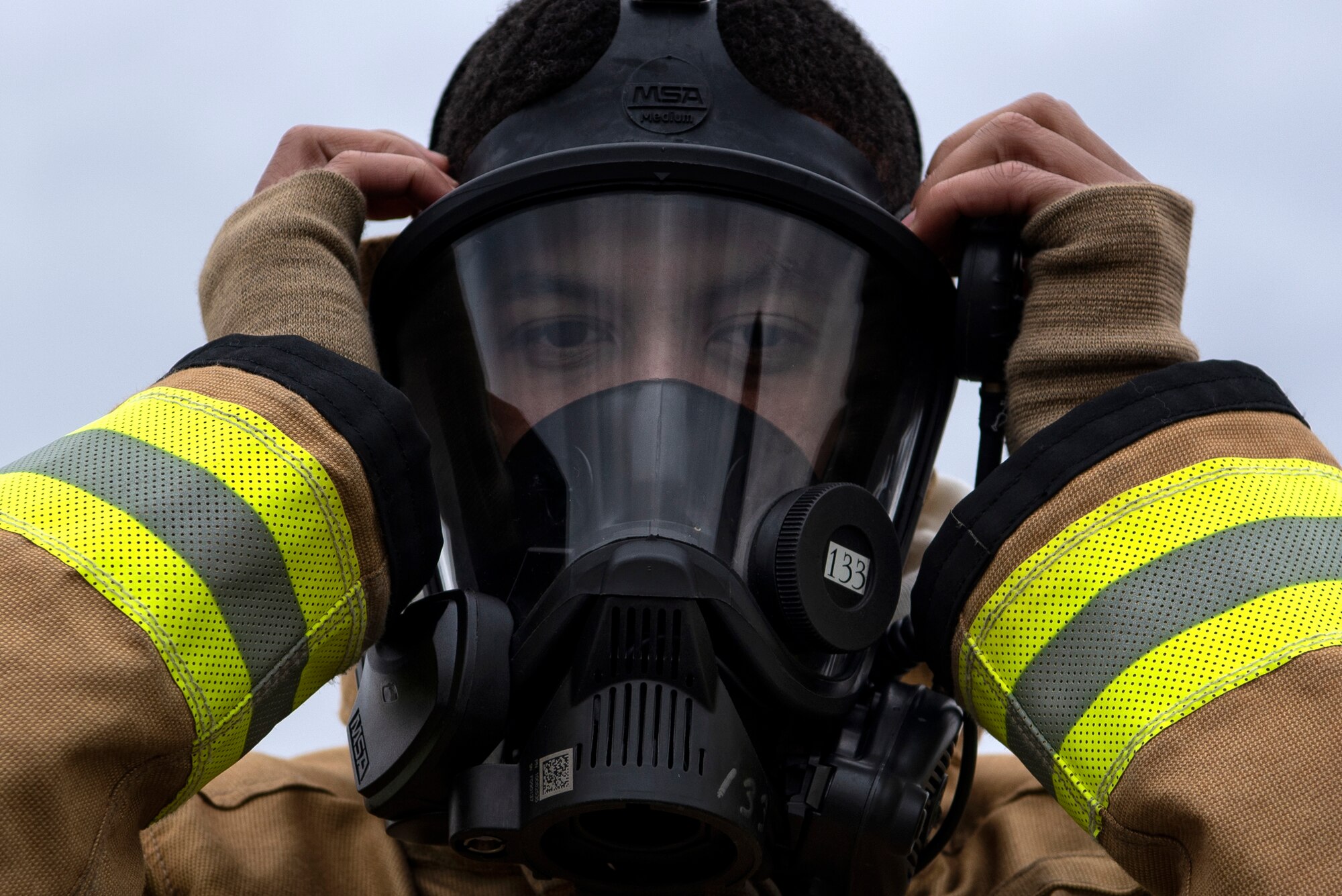 Omar Moylan, a senior at Spangdahlem High School, dons fire-protection gear at Spangdahlem Air Base, Germany, March 26, 2019. Moylan, who plans to enlist in the U.S. Air Force as a firefighter, participated in exercises with the 52nd Civil Engineer Squadron Fire Department as part of the school's Career Practicum program. (U.S. Air Force photo by Airman 1st Class Valerie Seelye)