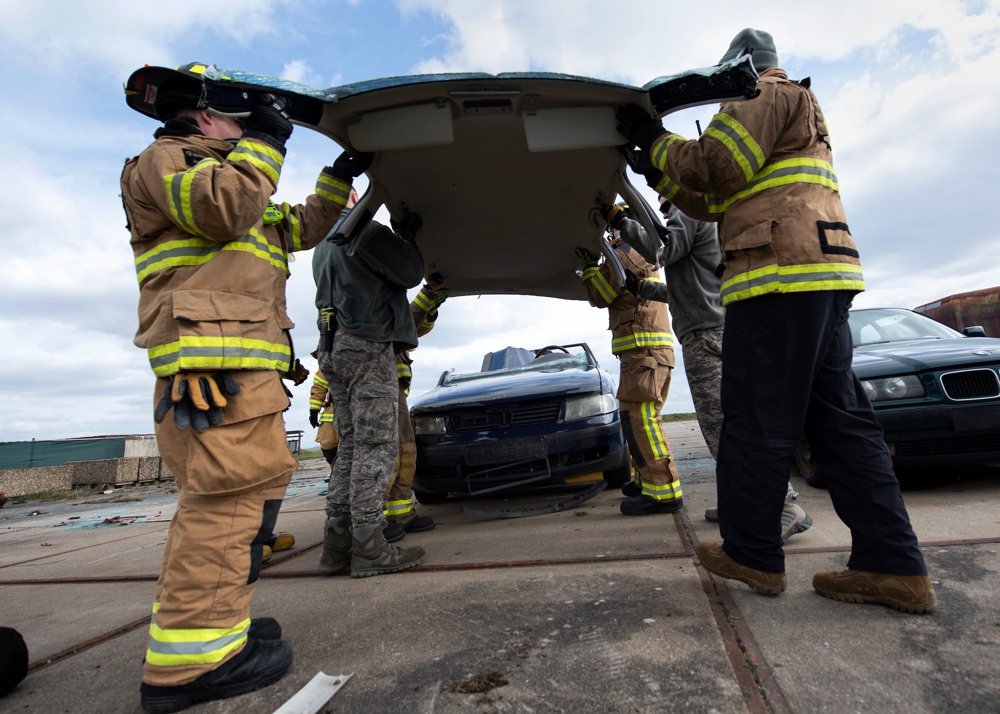 U.S. Air Force firefighters assigned to the 52nd Civil Engineer Squadron conclude a vehicle extrication exercise at Spangdahlem Air Base, Germany, March 26, 2019. Airmen cut through car glass and posts to simulate how to remove a patient from a car that has been in an incident. The exercise was part of the 52nd CES Fire Department's required training. (U.S. Air Force photo by Airman 1st Class Valerie Seelye)