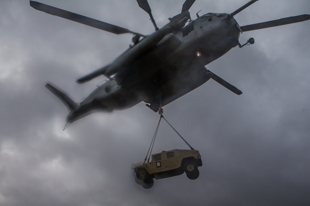 A CH-53E Super Stallion with Marine Heavy Helicopter Squadron 464, Marine Air Group 29, 2nd Marine Air Wing, lifts a Humvee with during a tactical recovery of aircraft and personnel training event with 2nd Transportation Support Battalion, Combat Logistics Regiment 2, 2nd Marine Logistics Group at Camp Lejeune, North Carolina, April 2, 2019. 2nd TSB held the training to maintain proficiency in day-to-night-external lifts.
