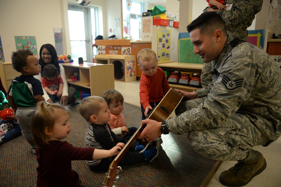 SSgt Alberto Rasado-Perez entertains children at the Offutt AFB Child Development Center with seasonal holiday music and instrumental demonstrations