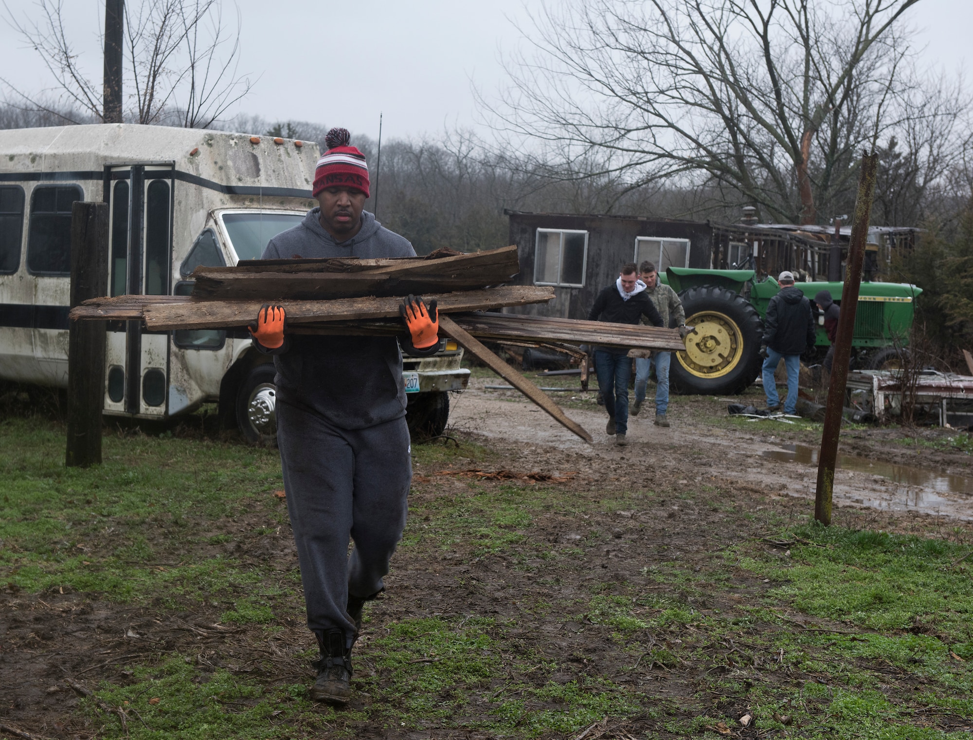 Tech. Sgt. Bryan Graham, police services NCO, carries a pile of wood on March 30, 2019.