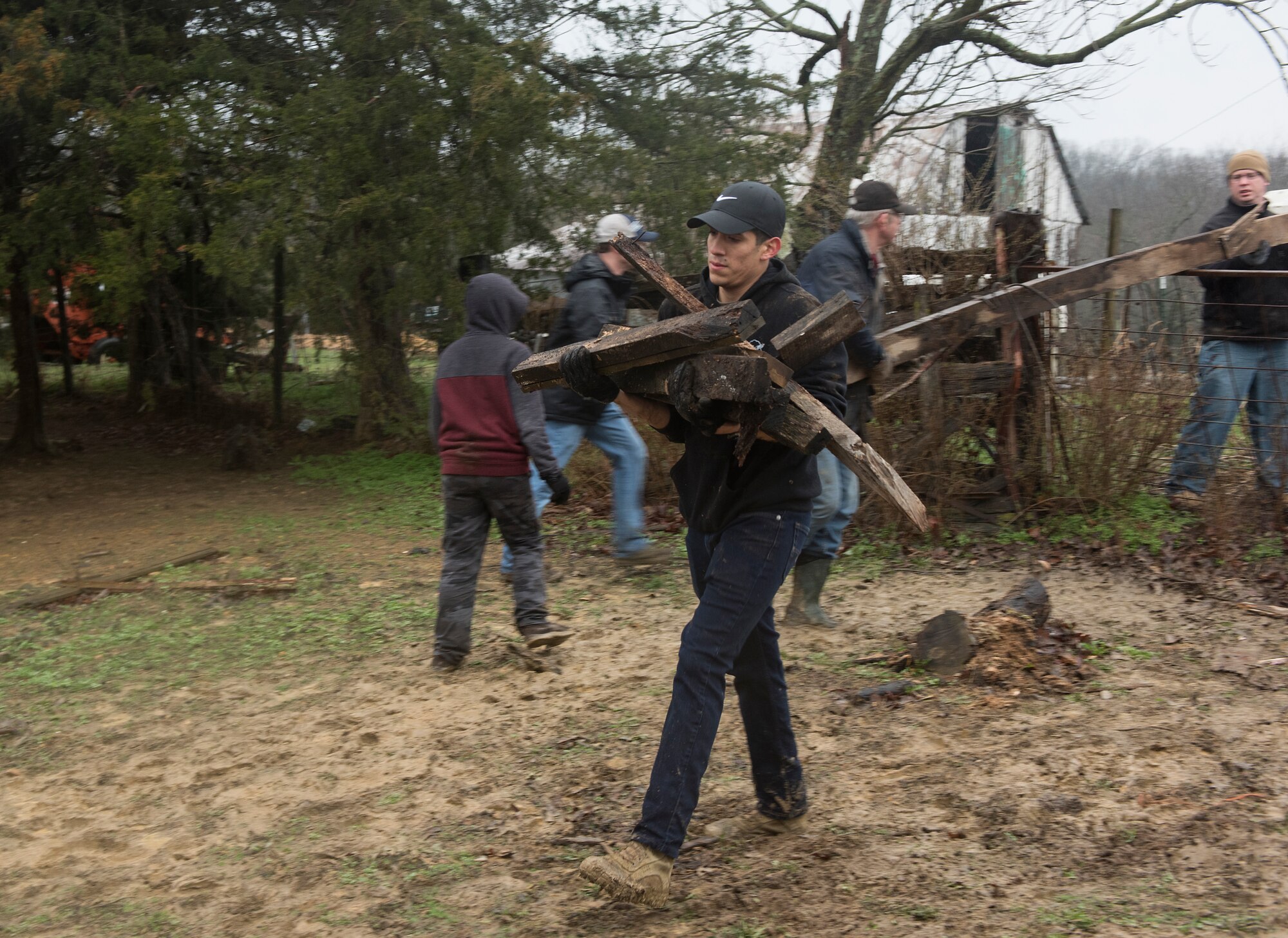 Airman 1st Class Miguel Tapia, assigned to the 509th Security Forces Squadron at Whiteman Air Force Base, Missouri, moves scrap wood to a pile.