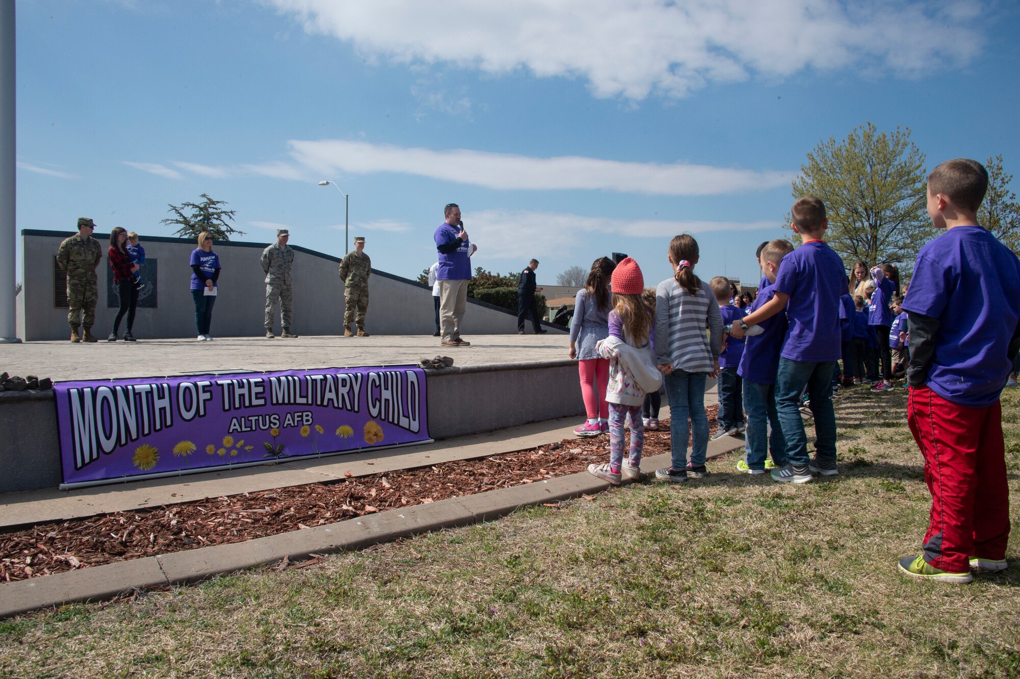 Trent Falon, 97th Force Support Squadron Chief of Child and Youth Services flight, gives a welcome speech for the Month of the Military Child parade, April 1, 2019, at Altus Air Force Base, Okla. Children across the 97th Air Mobility Wing gathered to celebrate Month of the Military Child and spread awareness. (U.S. Air Force photo by Senior Airman Cody Dowell)