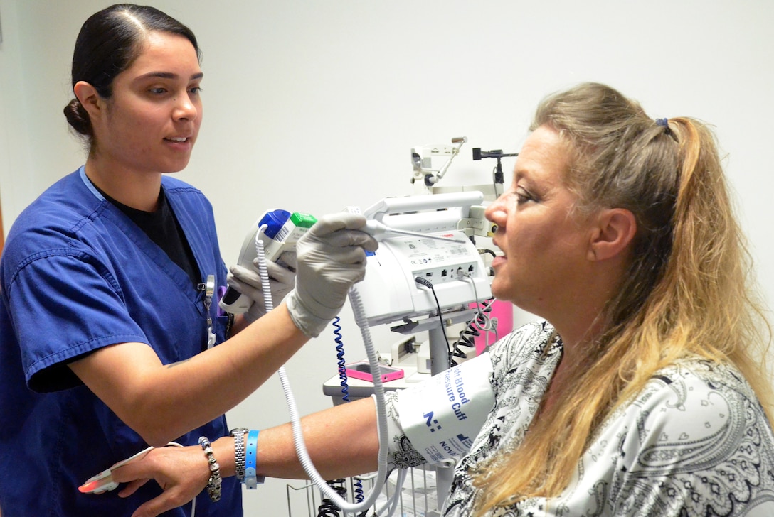 A woman provides another woman medical care.