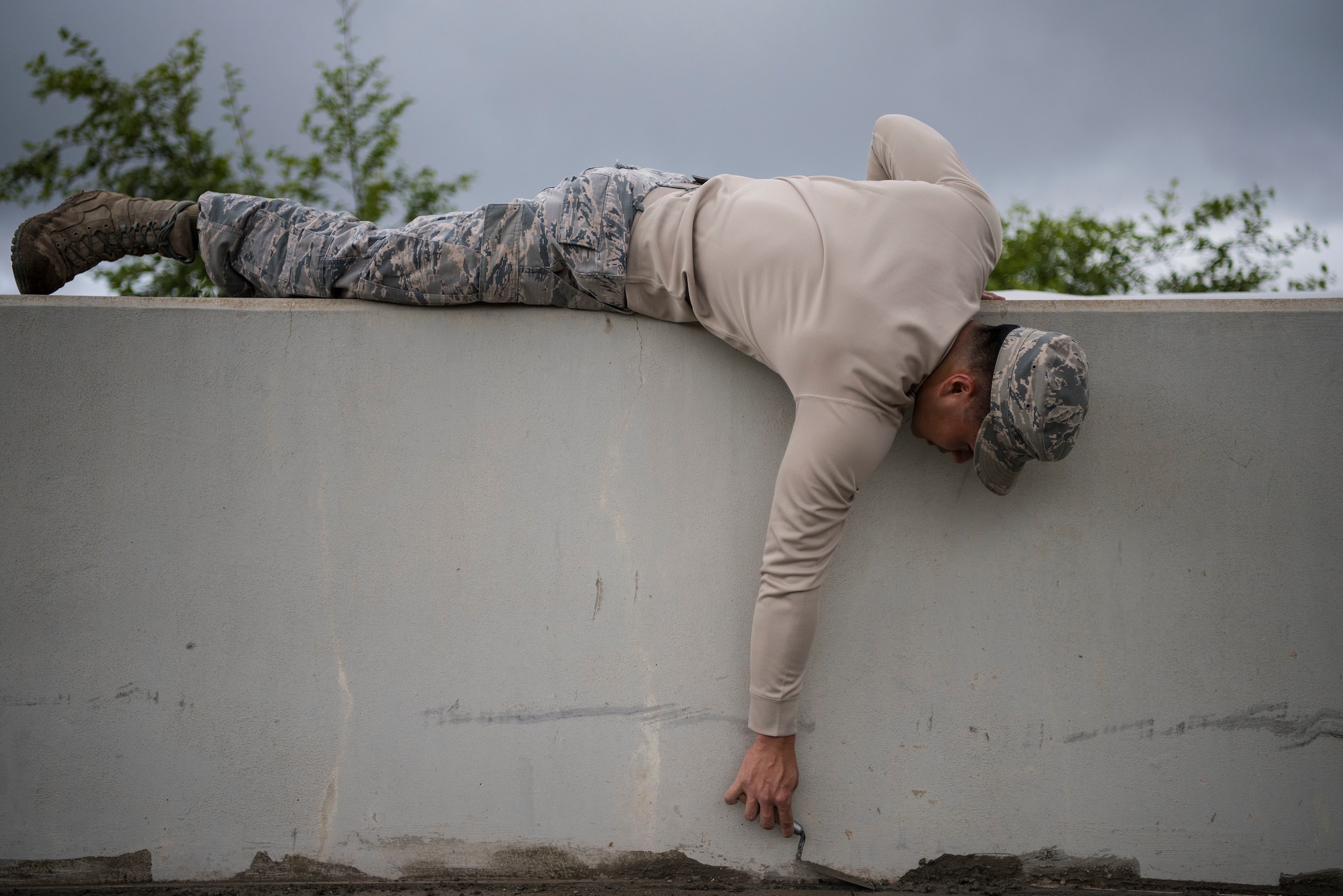 Senior Airman Noah Matsuura, 30th Civil Engineering Squadron Airman, evens out wet concrete April 3, 2019, at Vandenberg Air Force Base, Calif. Matsuura helps maintain Vandenberg AFB and provide repairs and upgrades when needed. (U.S. Air Force photo by Airman 1st Class Hanah Abercrombie)