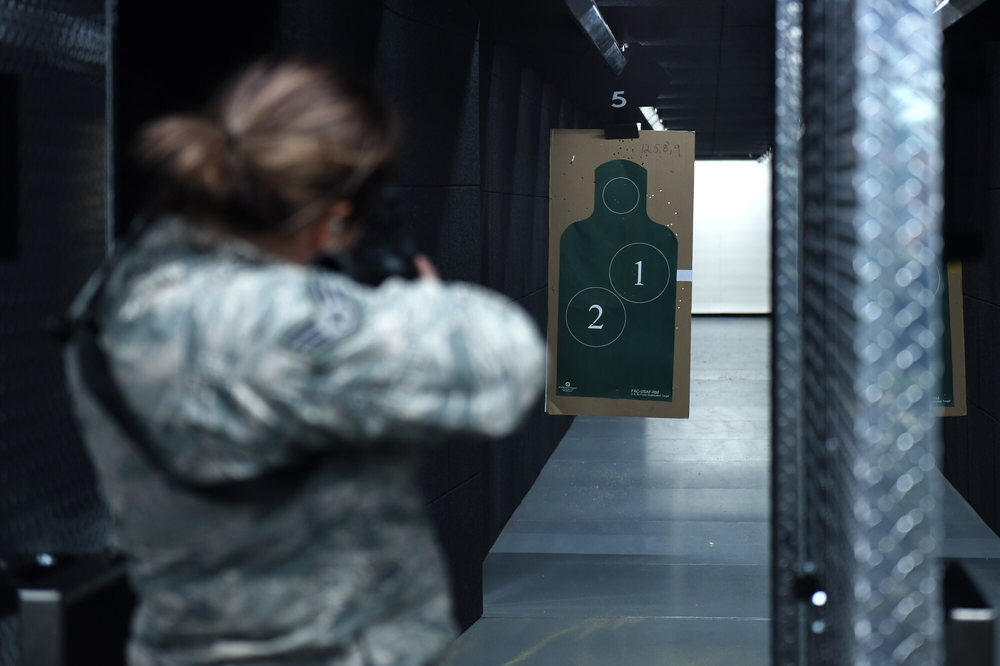 Staff Sgt. Jess Thebeau, munitions systems technician, assigned to the 180th Fighter Wing, Ohio Air National Guard, lines her shot up to the target during the first weapons qualification class in the new Modular Small Arms Range in Swanton, Ohio, Nov. 30, 2018. The high-tech facility is climate-controlled, has high efficiency air handlers, bullet traps and multiple simulation options that promotes safety, while providing scenario-based shooting situations for personnel to train and meet readiness requirements. (Air National Guard Photo by Senior Airman Hope Geiger)
