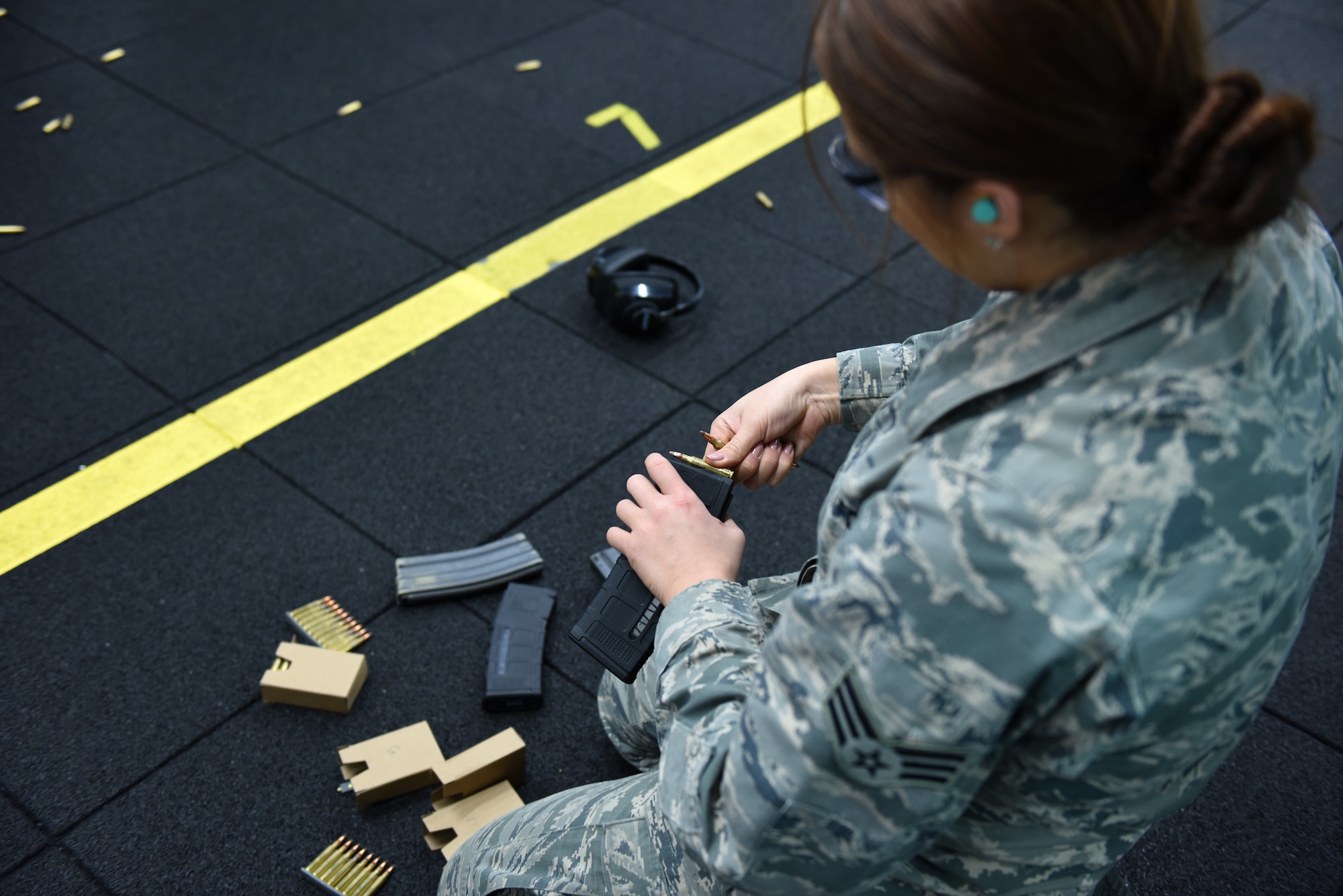 Senior Airman Conner Phillips, a munitions systems technician assigned to the 180th Fighter Wing, Ohio Air National Guard, loads ammunition during the first weapons qualification class in the new Modular Small Arms Range in Swanton. Ohio, Nov. 30, 2018. The high-tech facility is climate-controlled, has high efficiency air handlers, bullet traps and multiple simulation options that will promote safety, while providing scenario-based shooting situations for personnel to train and meet readiness requirements. (Air National Guard Photo by Senior Airman Hope Geiger)
