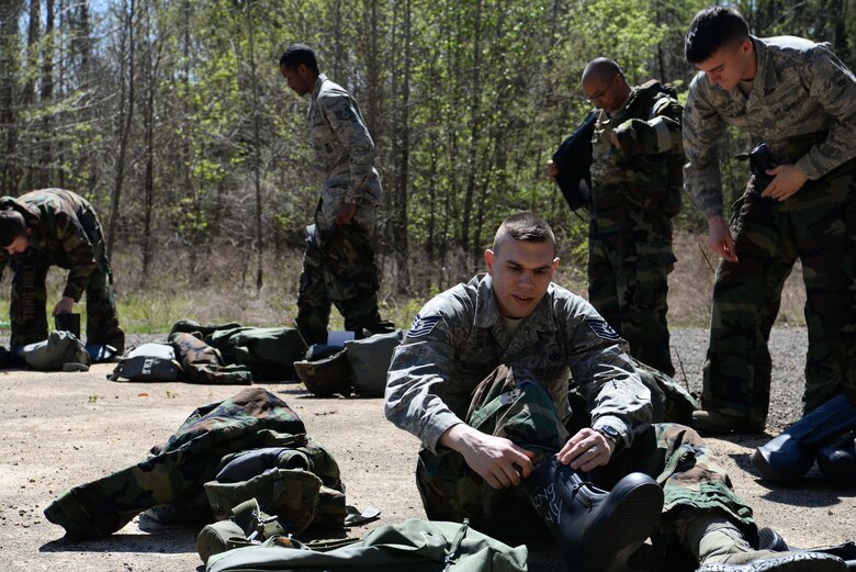 Tech. Sgt. Justin Nutter, 14th Security Forces Squadron, ties up his rubber boot as he puts on chemical biological, radiological and nuclear gear March 28, 2019, on Columbus Air Force Base, Miss. The good practice of putting on safety equipment plays a big role in the CBRN training to build confidence in Airmen so they will be ready to enter the chamber. (U.S. Air Force photo by Airman 1st Class Jake Jacobsen)