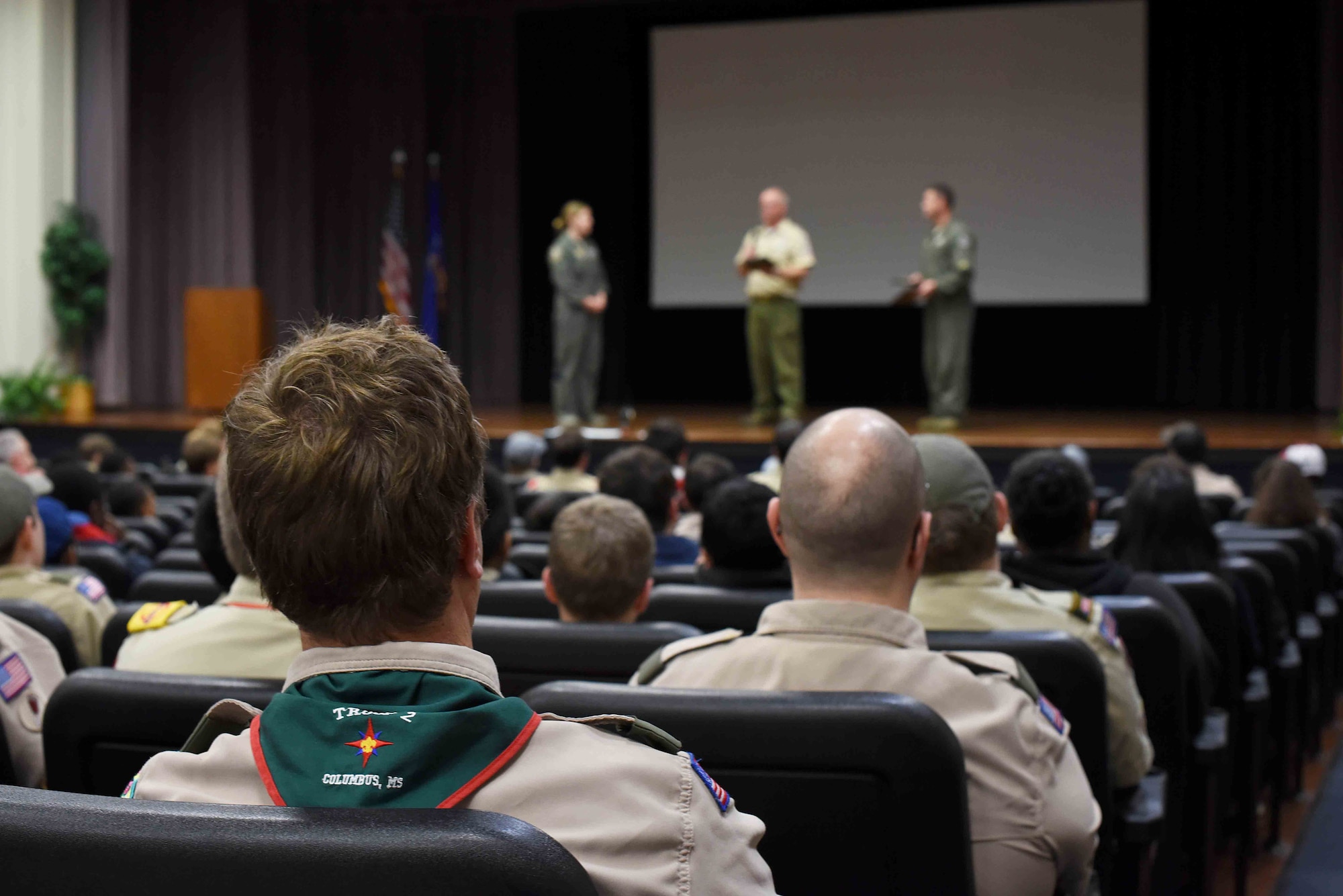 Scouts, Boy Scouts of America watch as their leadership present plaques to Col. Samantha Weeks, 14th Flying Training Wing commander, and Lt. Col. John Macasek, 49th Fighter Training Squadron commander, March 30, 2019, on Columbus Air Force Base, Mississippi. Scouts from the local area came to Columbus AFB and were able to learn about the flying training mission from 14th FTW Airmen. (U.S. Air Force photo by Airman 1st Class Keith Holcomb)