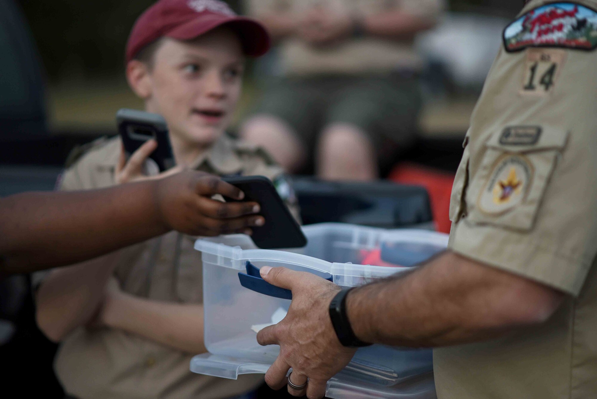 Scouts, Boy Scouts of America members give their phones to their troop leader March 29, 2019, on Columbus Air Force Base, Mississippi. Roughly 150 scouts were able to participate in the overnight camping event on Columbus AFB. (U.S. Air Force photo by Airman 1st Class Keith Holcomb)