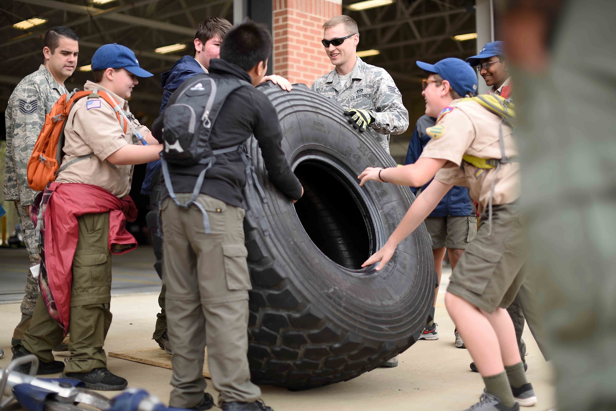 Scouts, Boy Scouts of America members try to push a tire with 14th Civil Engineer Squadron firefighters March 30, 2019, on Columbus Air Force Base, Mississippi. There were many hands-on activities to teach scouts of all ages what different careers in the Air Force do. (U.S. Air Force photo by Airman 1st Class Keith Holcomb)