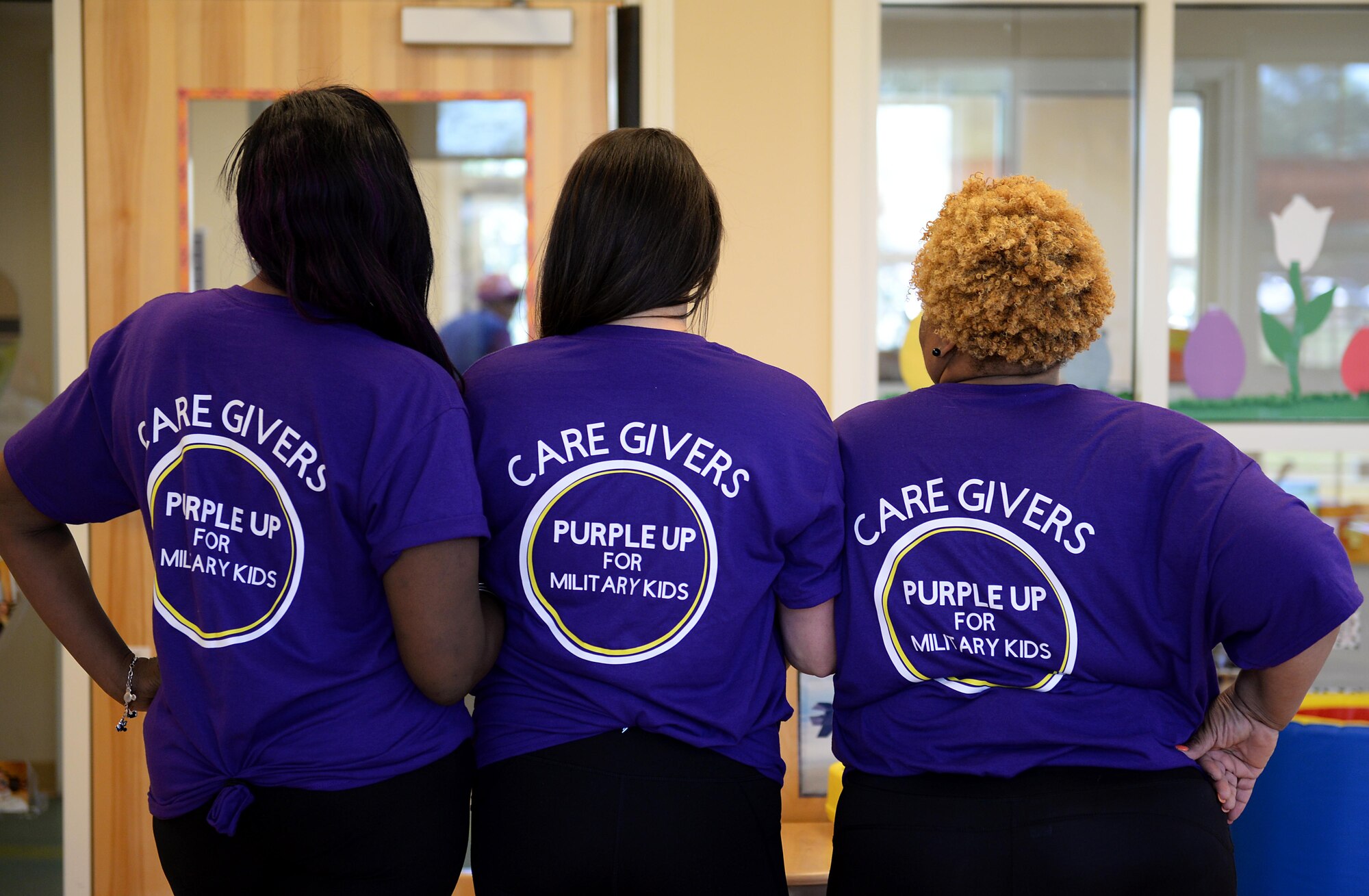 Child Development Center caregivers show off their Purple Up shirts April 1, 2019 on Columbus Air Force Base, Miss. One upcoming event for Month of the Military Child is “Purple Up!” Day, where everyone wears purple in honor of military children.  (U.S. Air Force photo by Airman Hannah Bean)