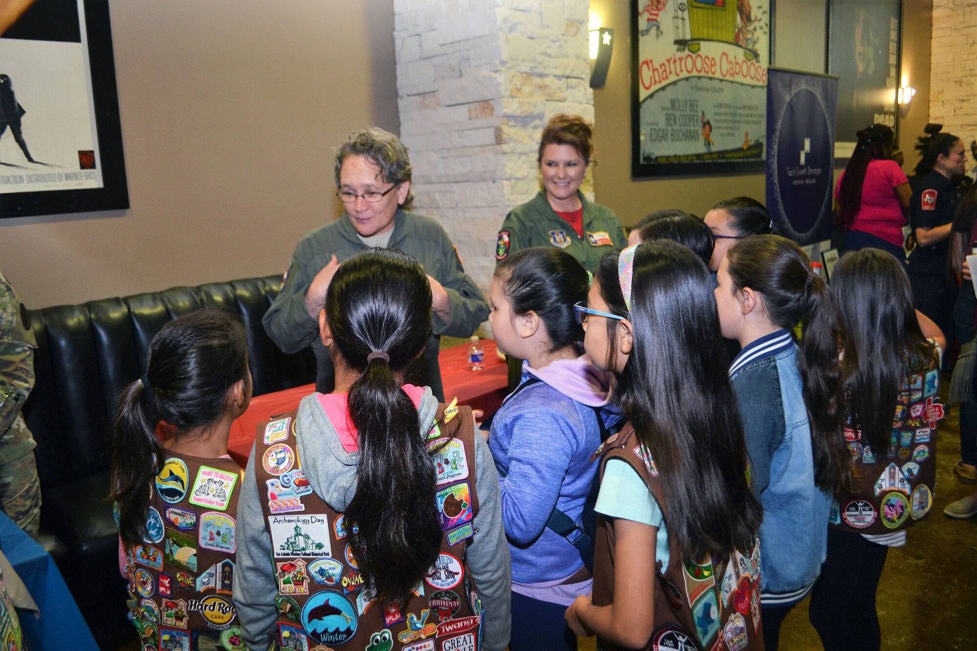 ech. Sgt. Debra Harper (left), 68th Airlift Squadron loadmaster, and Lt. Col. Kari Hill, 433rd Operations Support Squadron commander/pilot, both with Joint Base San Antonio-Lackland, Texas, talk with girls attending the “Marvelous Women Don’t Need Capes” event.