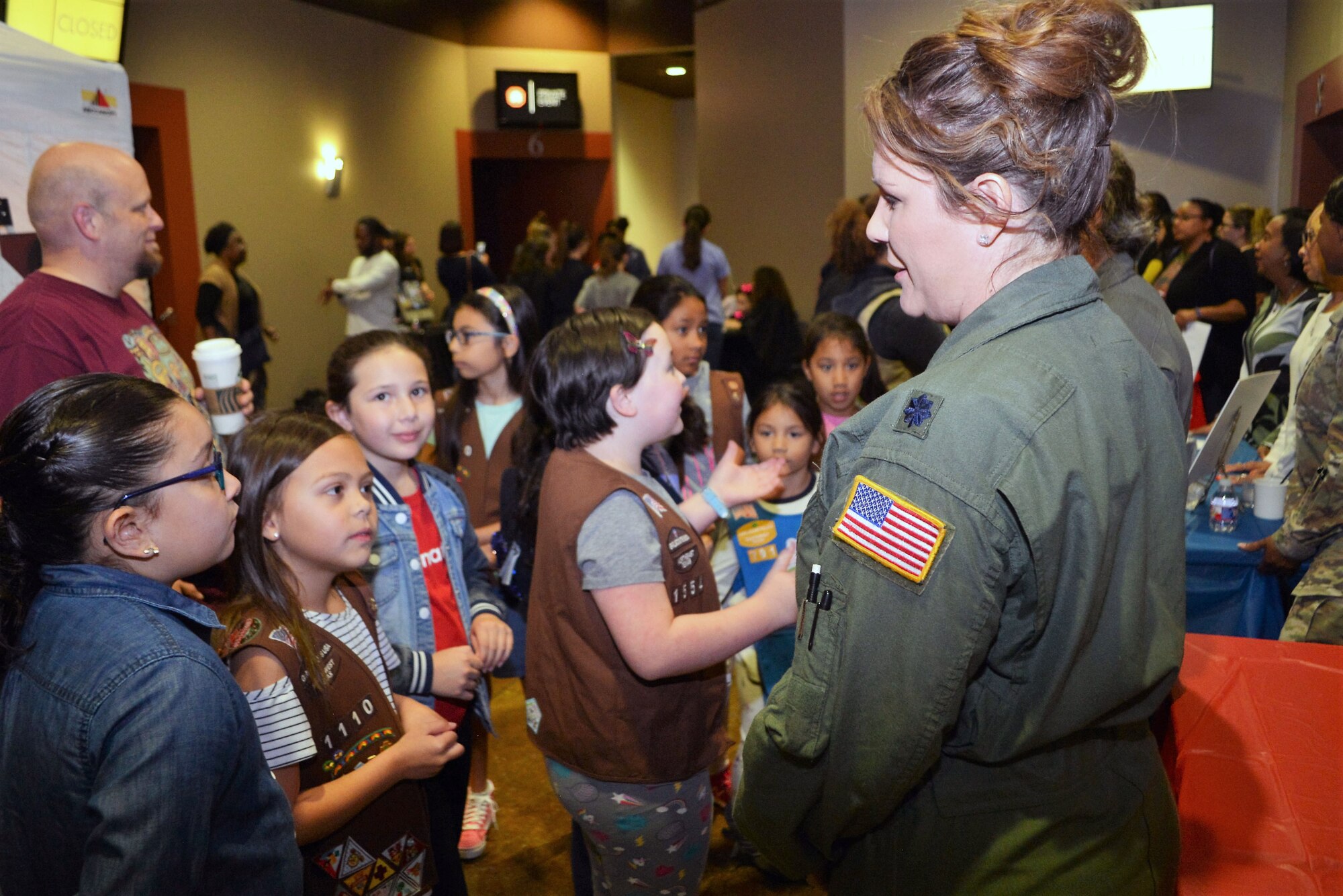 Lt. Col. Kari Hill, a C-5M Super Galaxy aircraft pilot and squadron commander with the 433rd Operations Support Squadron, Joint Base San Antonio-Lackland, Texas talks, one-on-one, with a group of girls attending the “Marvelous Women Don’t Need Capes” event.