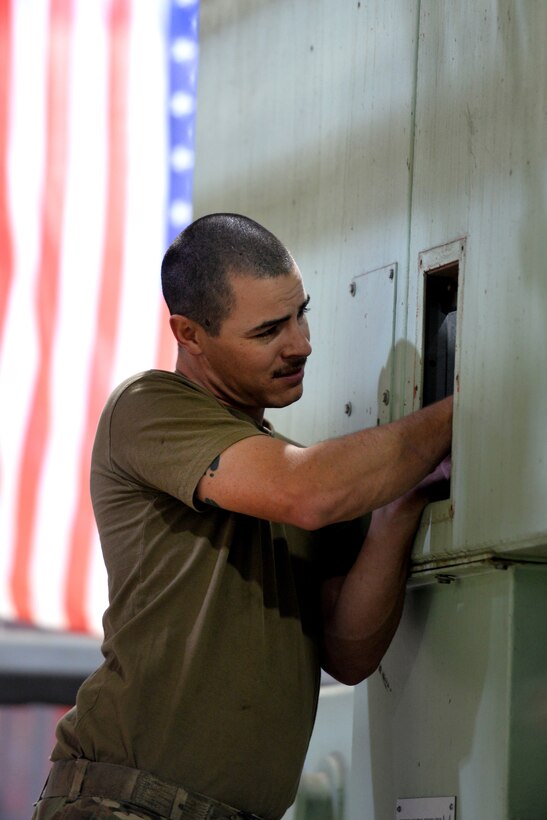 Staff Sgt. Logan Burnett, an electrician with the Civil Engineer Center's Civil Engineer Maintenance Inspection Repair Team, inspects a generator at Offutt Air Force Base, Nebraska, March 29, 2019. Offutt experienced record flooding due to a variable of conditions prompting teams from the Air Force Civil Engineer Center - a unit responsible for providing rapid response to disaster areas around the globe, to help aid in the Offutt, flood recovery. (U.S. Air Force photo by Josh Plueger)