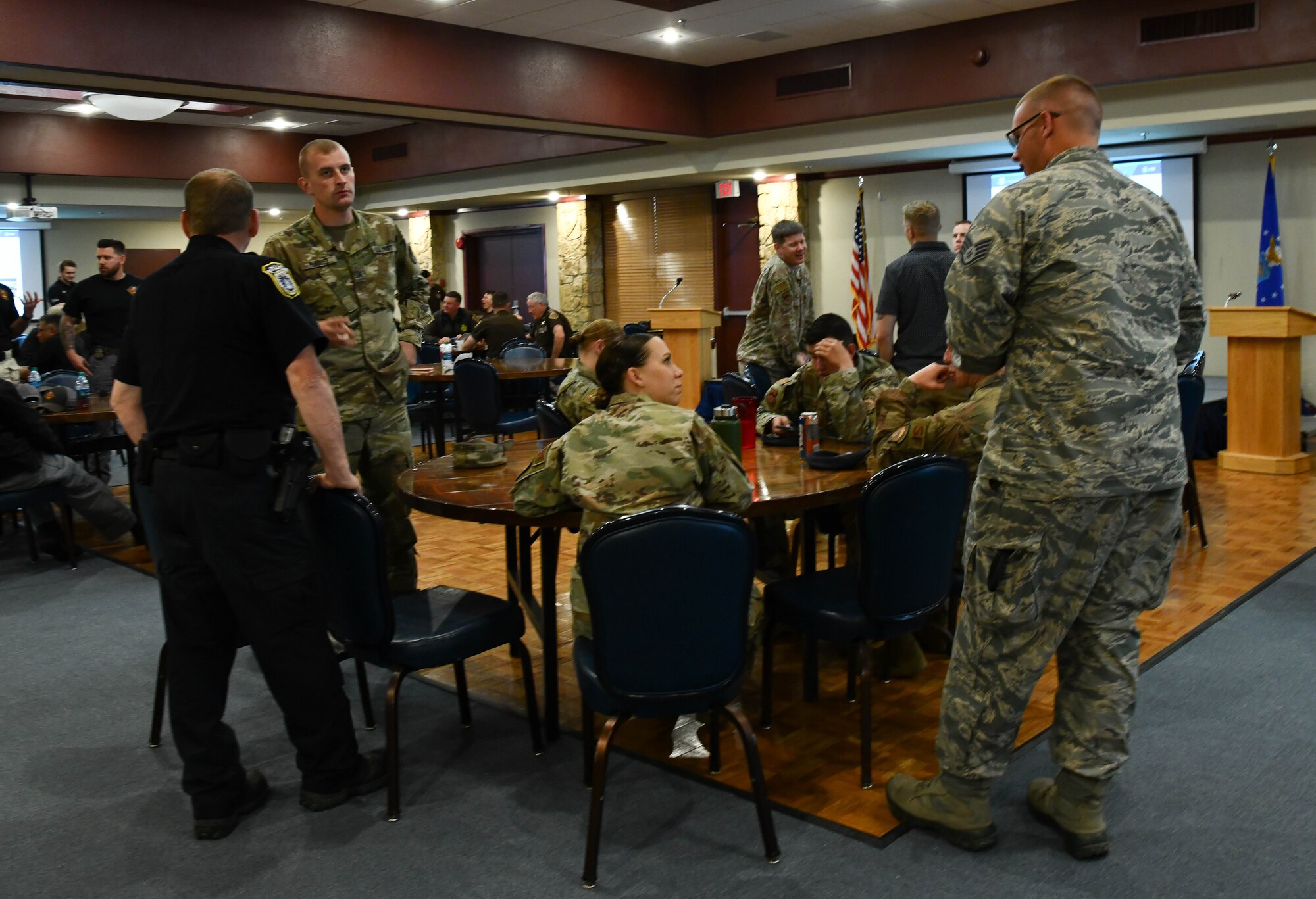 Law enforcement officers of Oklahoma socialize during a break in the bomb technician briefings, Mar. 29, 2019, at Altus Air Force Base, Okla. The training was designed to provide first responders with updated information on current threats.  (U.S. Air Force photo by Airman First Class Dallin Wrye)
