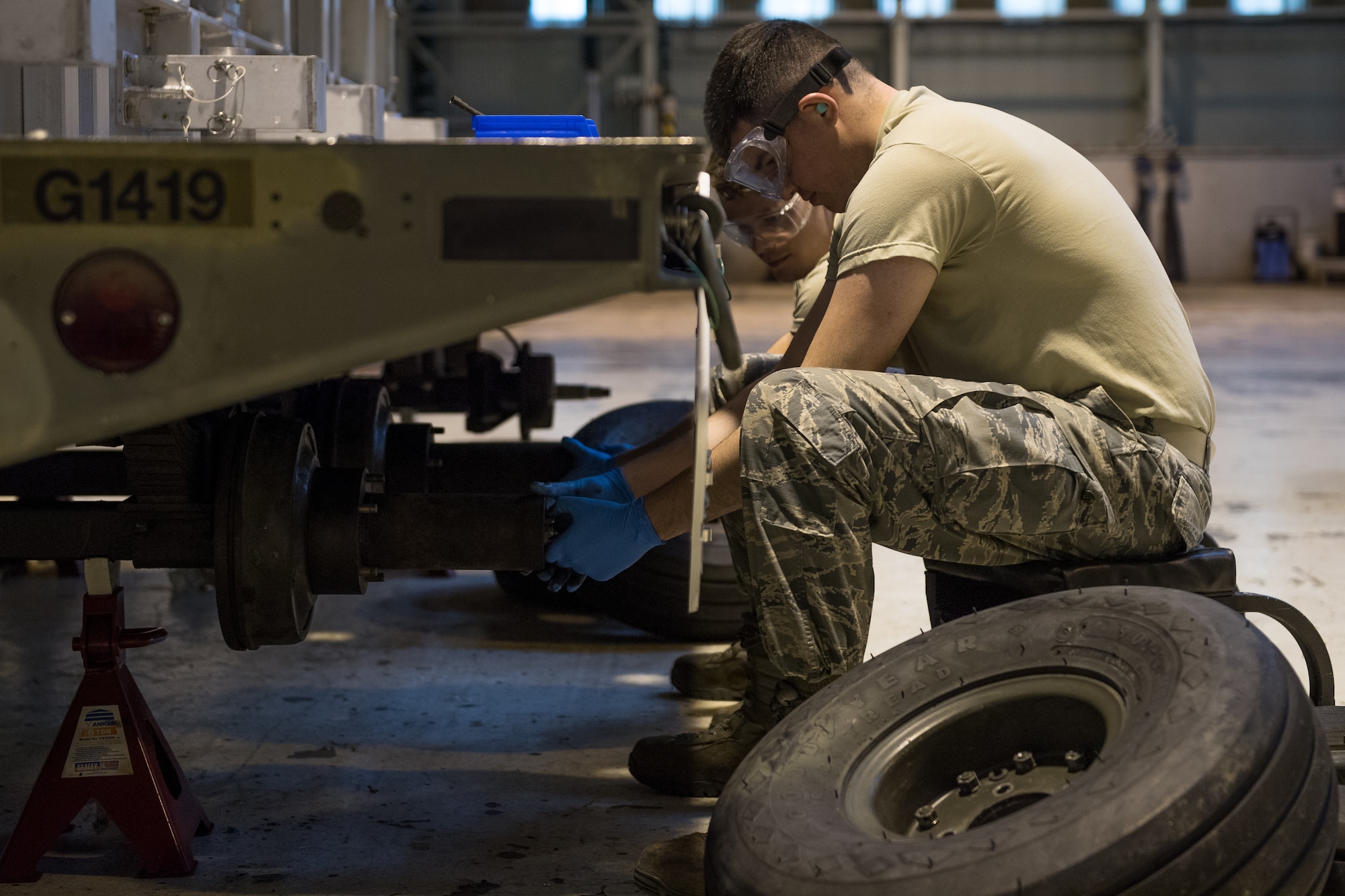 Airman 1st Class Landon Gonzales, 2nd Munitions Squadron conventional maintenance crew chief, replaces a hub on a MHU-110 munitions trailer during a U.S. Strategic Command Bomber Task Force in Europe at RAF Fairford, England, April 2, 2019. The 2nd MUNS brought Airmen for their primary duties and extra Airmen for the additional jobs such as the trailer maintenance. (U.S. Air Force photo by Airman 1st Class Tessa B. Corrick)