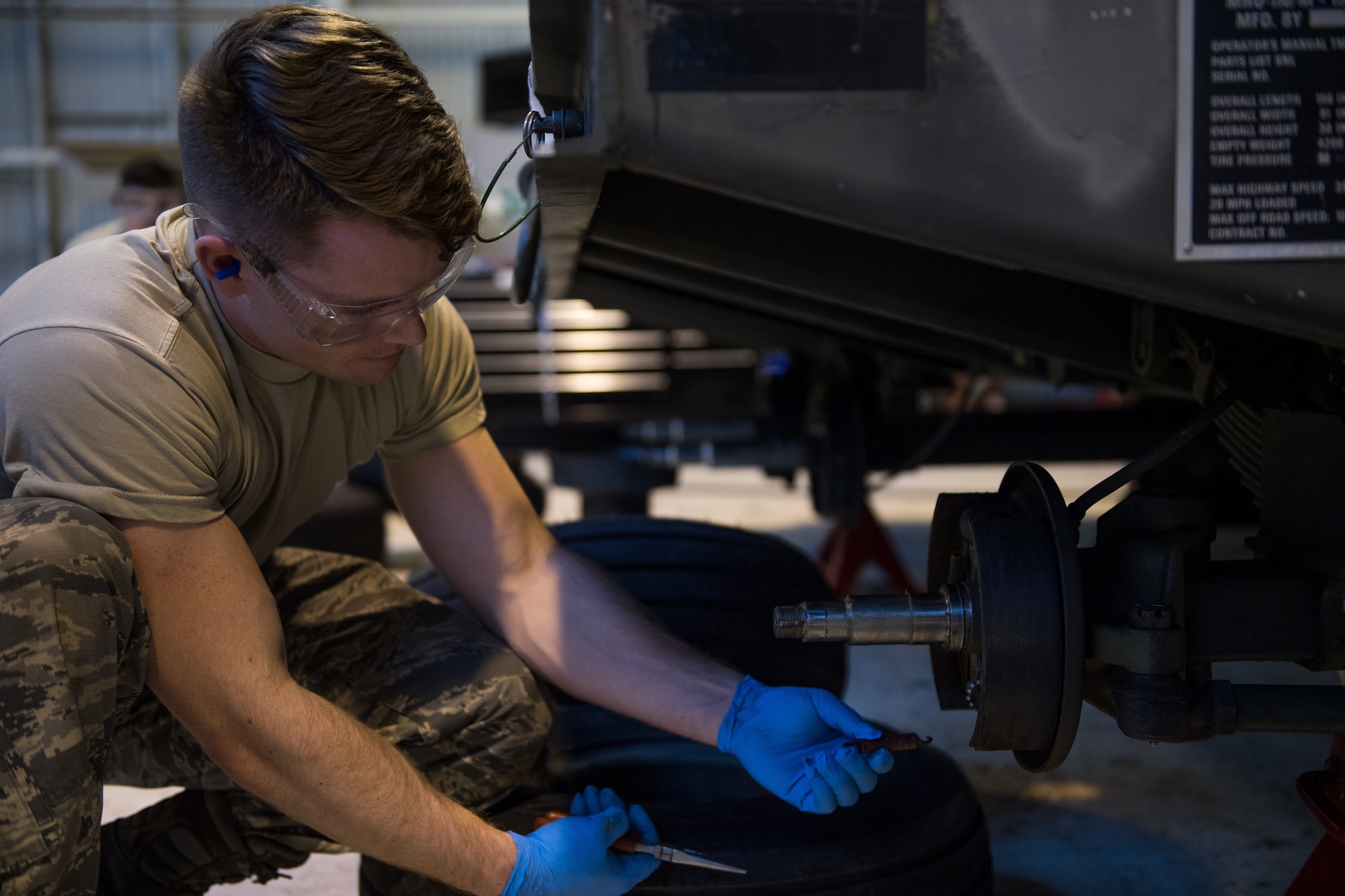 Airman 1st Class Jerrick Worley, 2nd Munitions Squadron munitions systems equipment maintenance crew chief, replaces a spring on a MHU-110 munitions trailer at RAF Fairford, England, April 2, 2019. Fairford has more than 35 munitions trailers on base and 2nd MUNS Airmen have been able to return more than 15 of them to serviceability. (U.S. Air Force photo by Airman 1st Class Tessa B. Corrick)