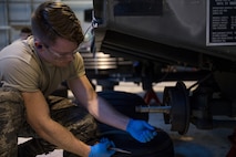 Airman 1st Class Jerrick Worley, 2nd Munitions Squadron munitions systems equipment maintenance crew chief, replaces a spring on a MHU-110 munitions trailer at RAF Fairford, England, April 2, 2019. Fairford has more than 35 munitions trailers on base and 2nd MUNS Airmen have been able to return more than 15 of them to serviceability. (U.S. Air Force photo by Airman 1st Class Tessa B. Corrick)