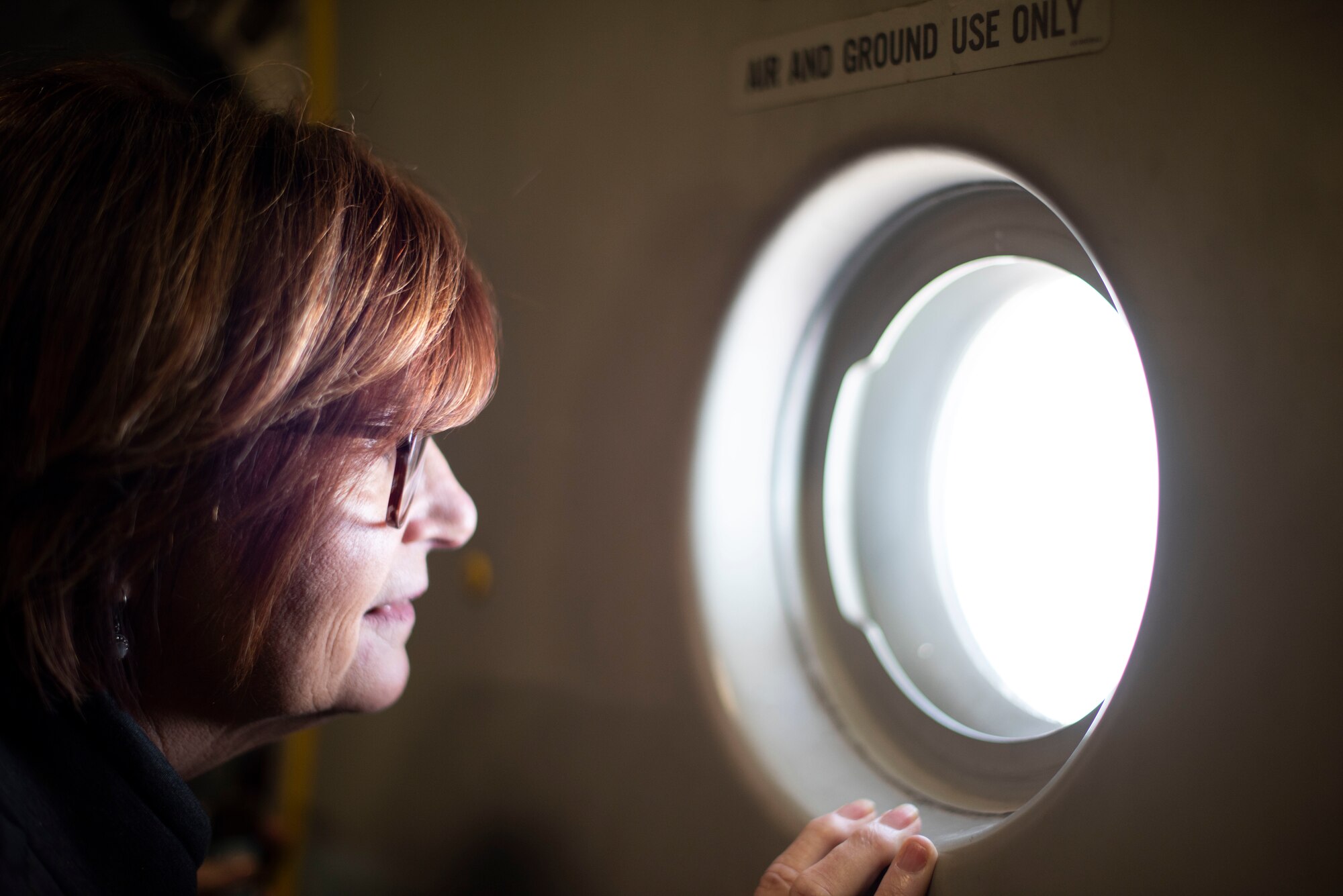 Maureen Allain, Northbay Medical Center registered nurse and Hometown Hero, looks out a window on a C-17 Globemaster III, March 25, 2019. This year Travis had 27 individuals nominated by their peers to be Hometown Heroes for “Thunder Over the Bay” airshow. (U.S. Air Force photo by Airman 1st Class Jonathon Carnell)