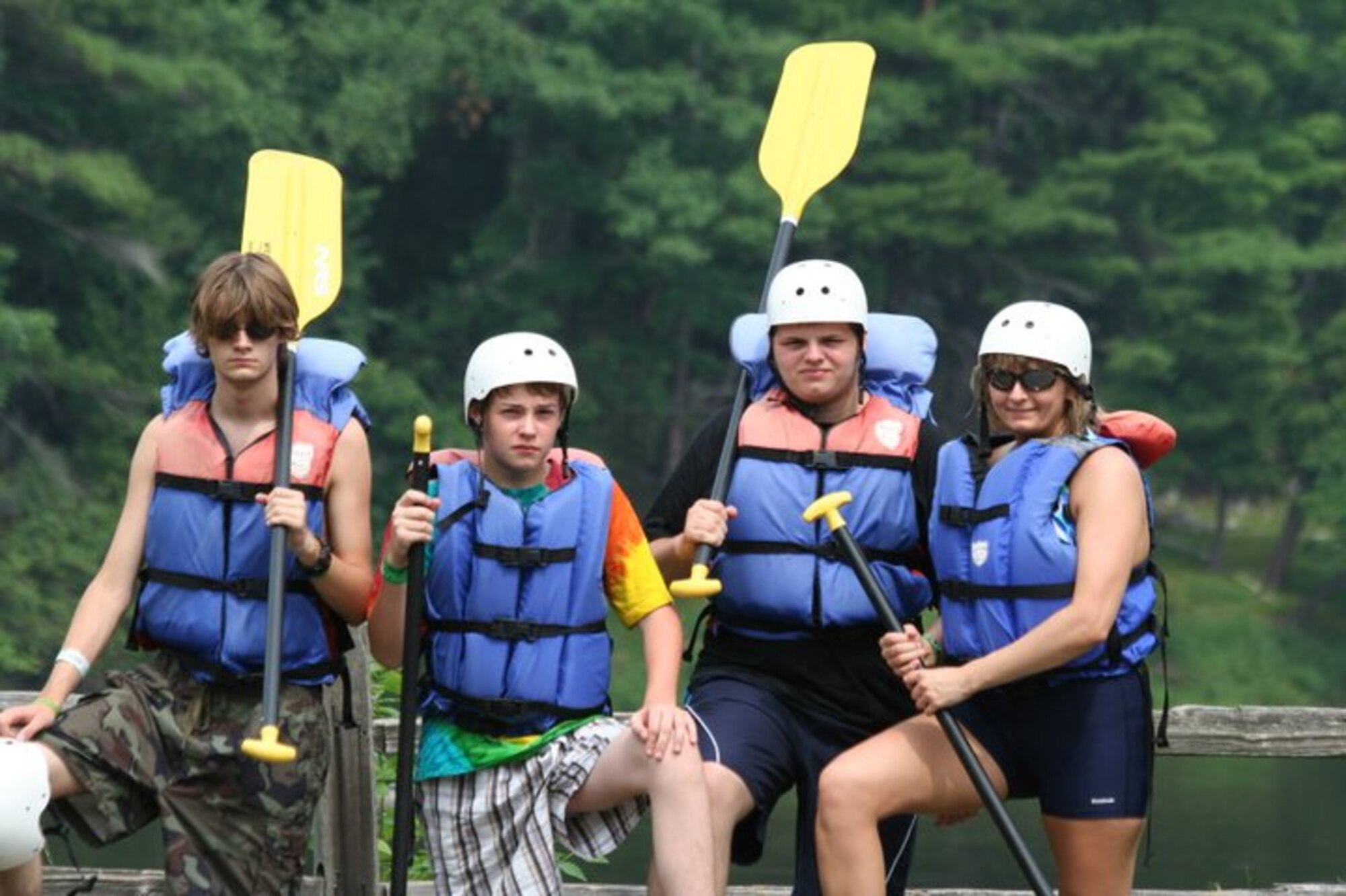 U.S. Air Force Maj. Donna Sicker, 374th Medical Group group practice manager and alternate sexual assault response coordinator out of Yokota Air Base, Japan, right, poses for a photo with her sons Devon, center right, Dallas, center left, and Colt, left, before going whitewater rafting on the Menominee River near Niagra, Wisconsin, Aug. 2011. In spending time with her family, Sickler was able reach her new normal after being the victim of a sexual assault in April of 2011. Today, after years of healing, Sickler uses the power of her story to help others overcome their own traumas through the Sexual Assault Prevention and Response program. (Courtesy photo by U.S. Air Force Maj. Donna Sickler)